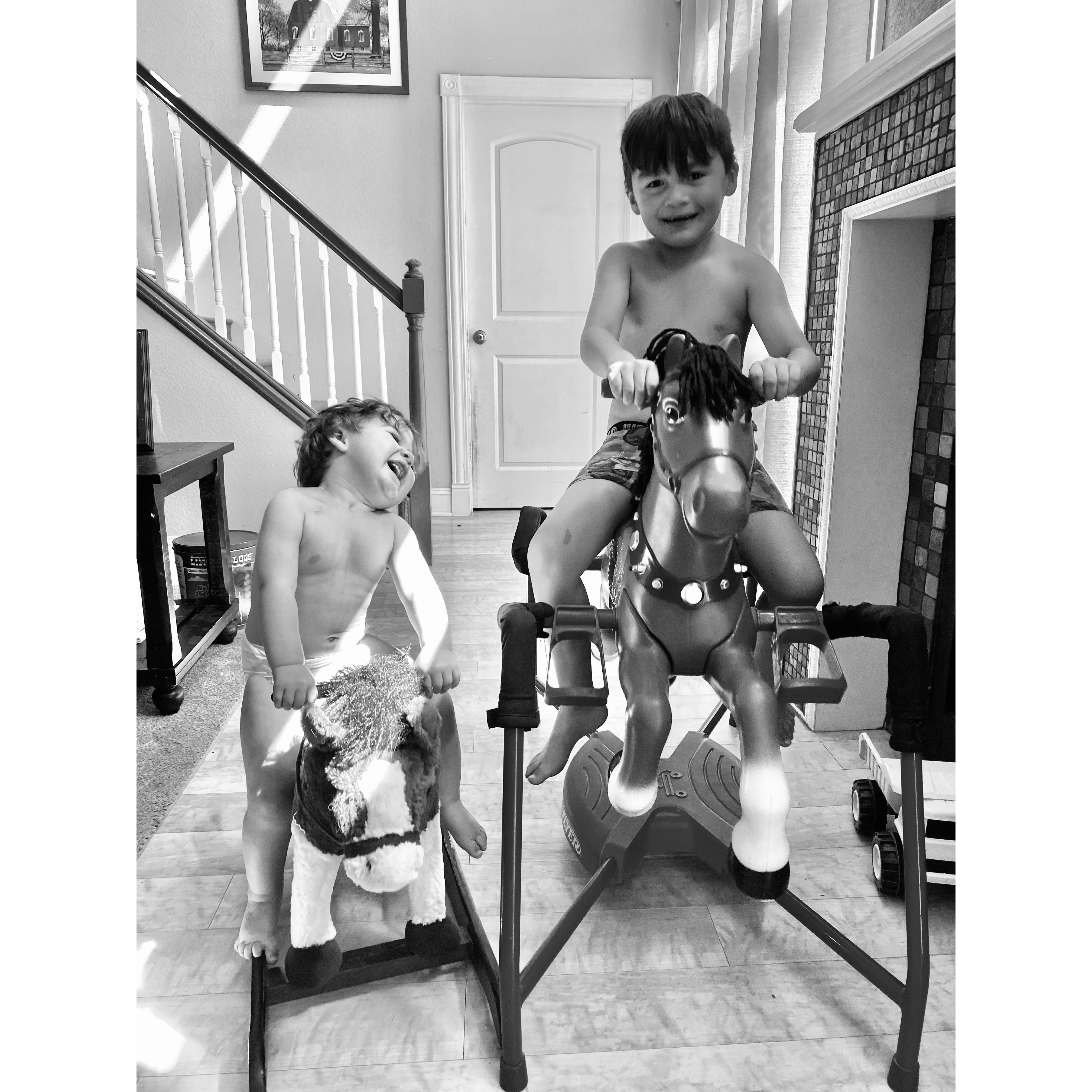 The boys riding their horses