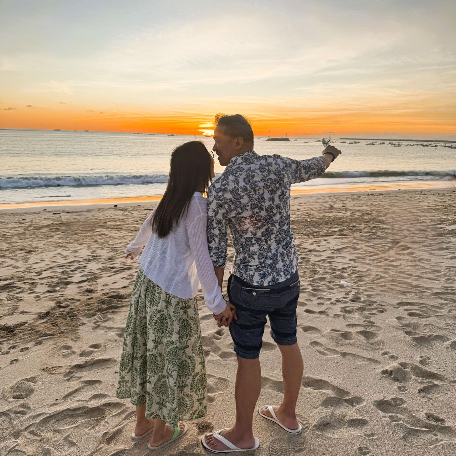 Watching the sunset over a romantic dinner and live music by the beach at Jimbaran Beach in Bali, Indonesia