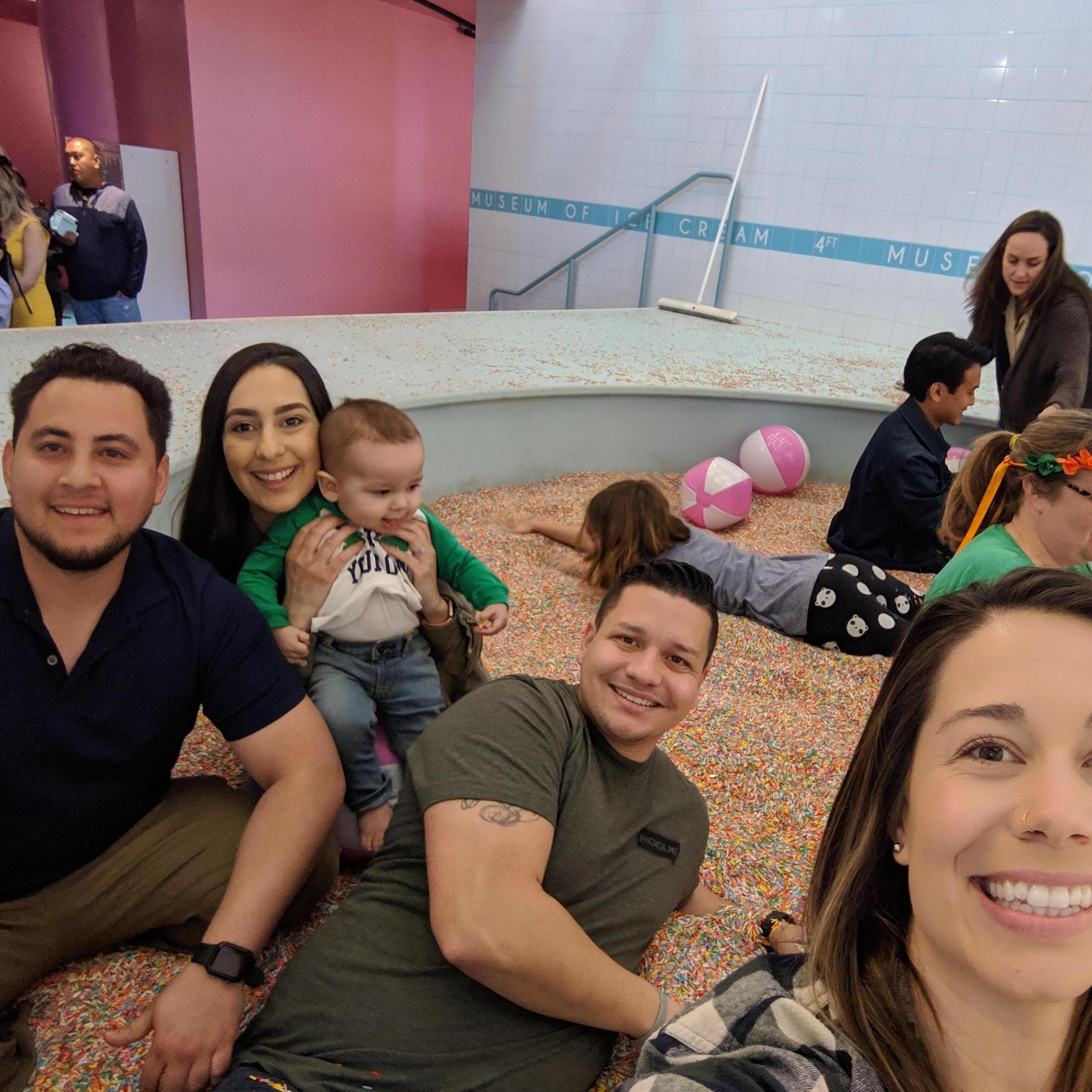 Playing in the sprinkle pool at the museum of ice cream