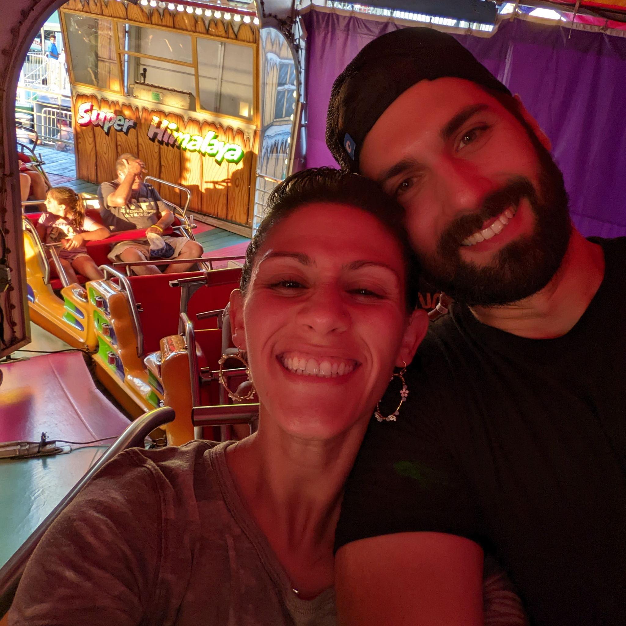 2 adults riding the Himalaya at Point Pleasant pre-Jenks summer concert