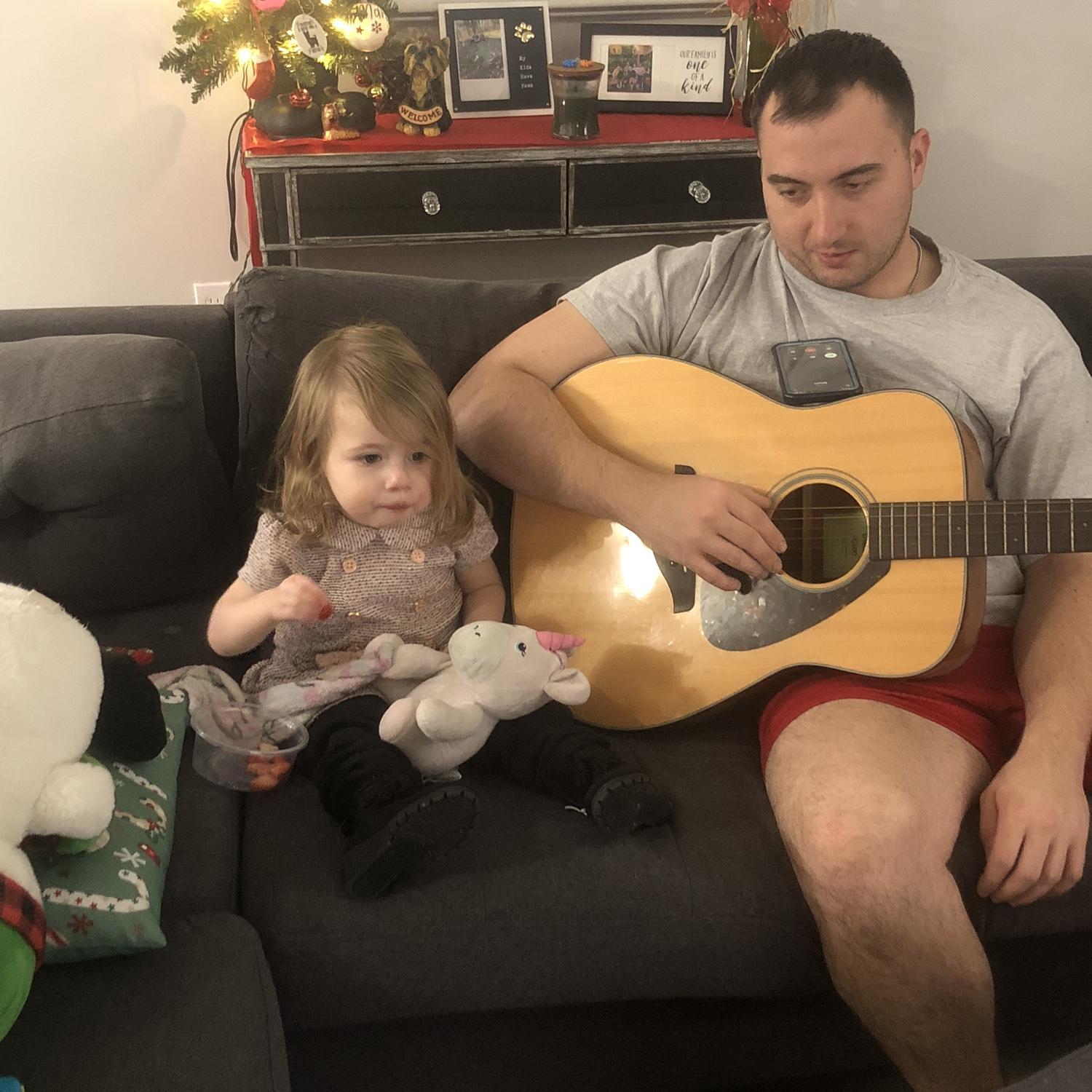 Matt tried teaching Winter how to play guitar... she decided she wanted to eat and watch TV instead