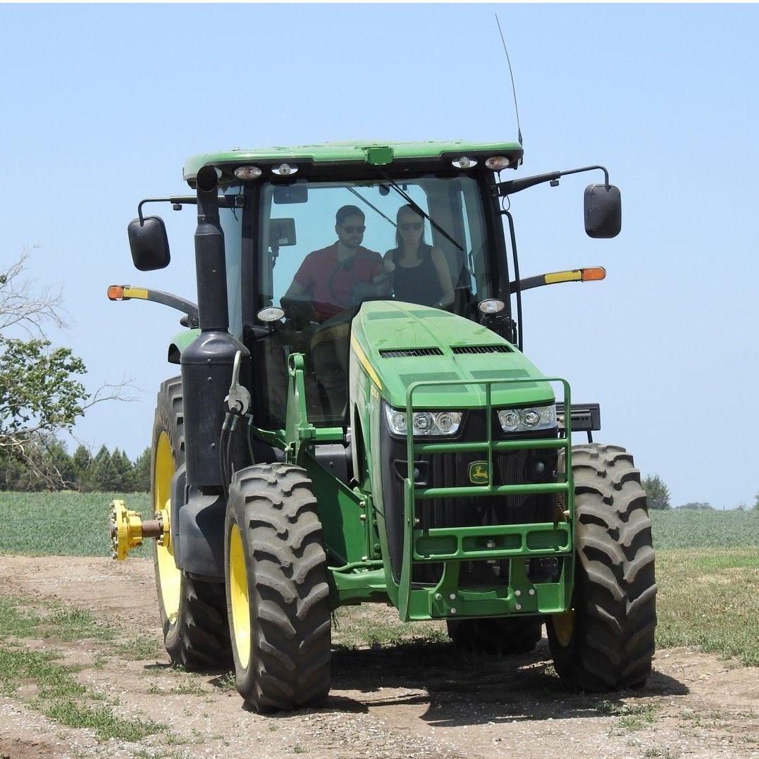 Driving a tractor on Adam's family farm in Nebraska.