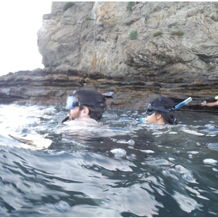 Snorkling in Nicaragua. Our favorite part of this photo is the random man clinging to the rocks for dear life. He's a bit hard to see in the cropped photo.