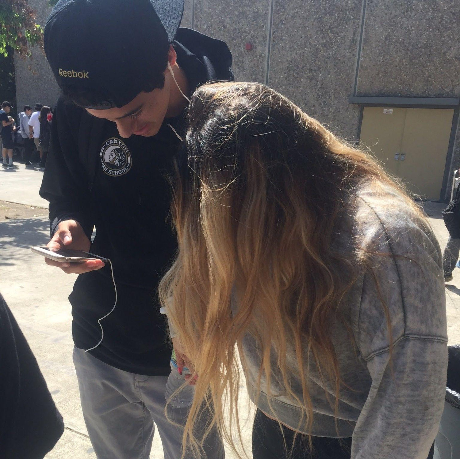 Our first photo together, sneakily taken by a friend in the lunch line. He was showing me what he was listening to on those earphones he had on 24/7. I believe it was Future.