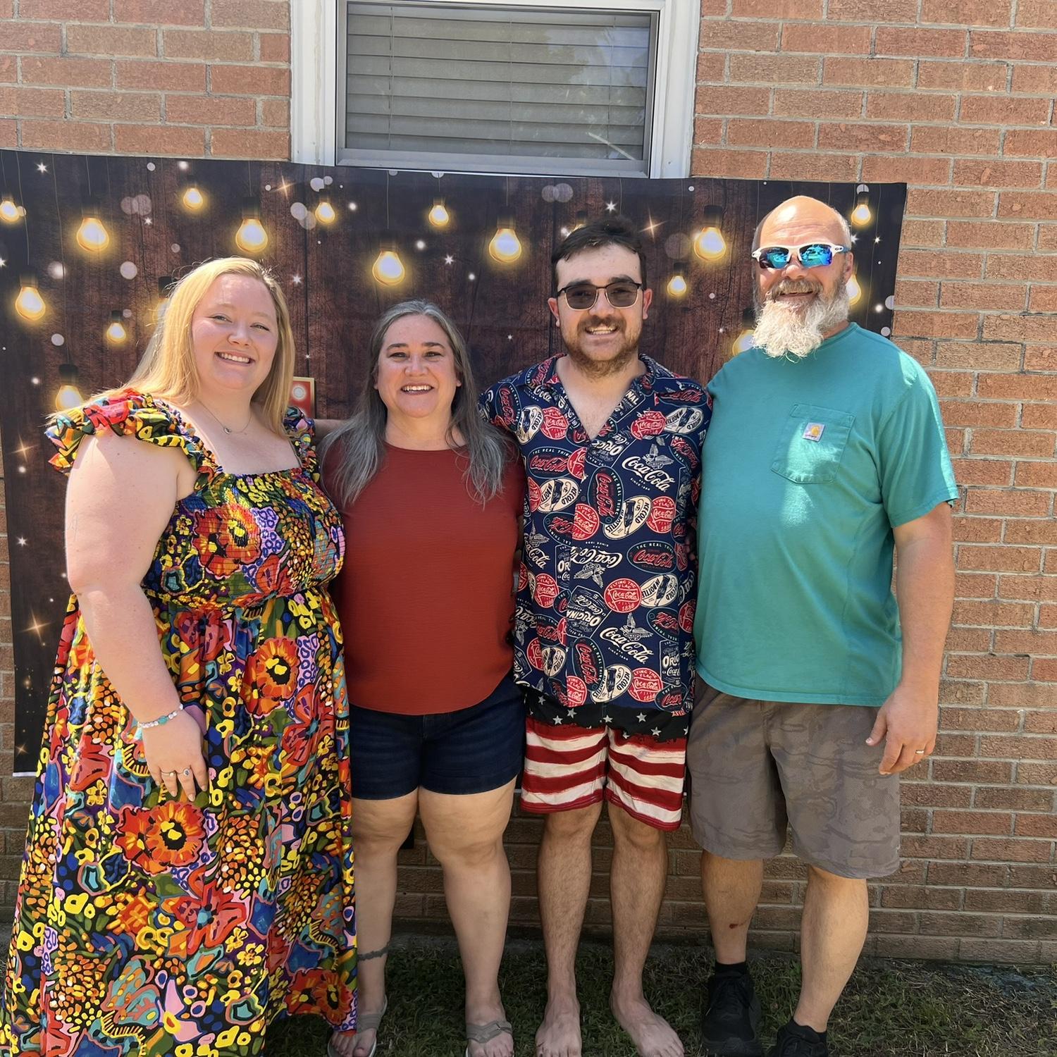 Caleb, Austyn, and Caleb's parents at their engagement party!