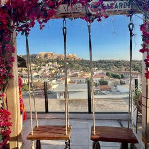 Buy us a drink at a rooftop bar in Greece