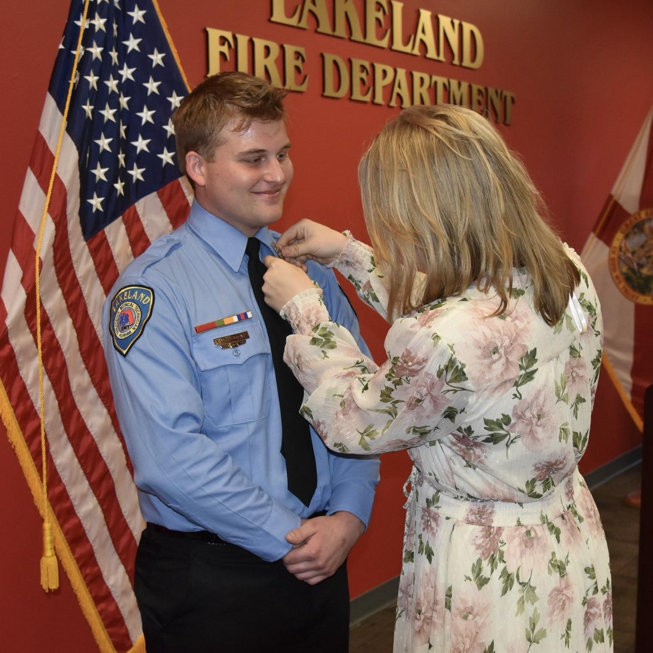 Anneliese pins Taylor at his 1-year ceremony at the Lakeland Fire Department.