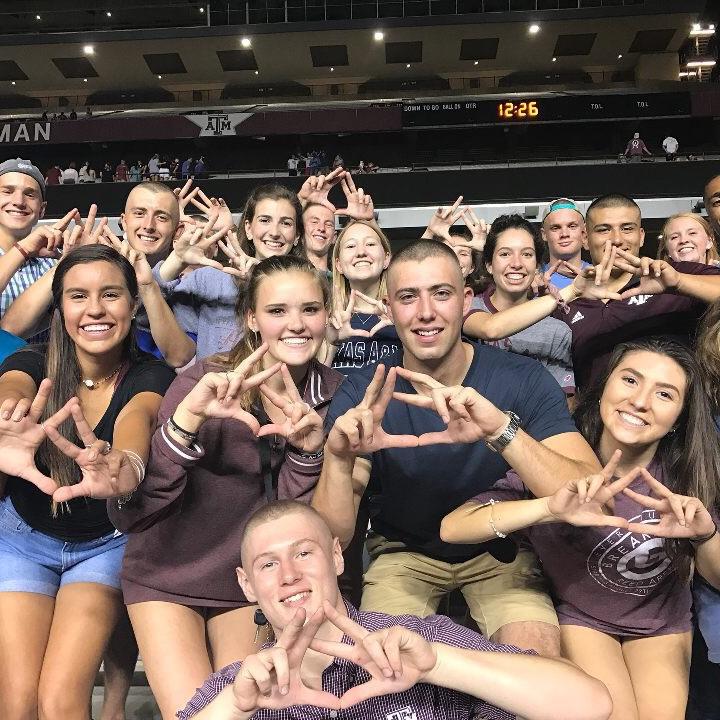 The night we met at Midnight Yell - we had maybe said a few words to each other before this photo but still ended up right next to one another (gotta love bald Caleb)!