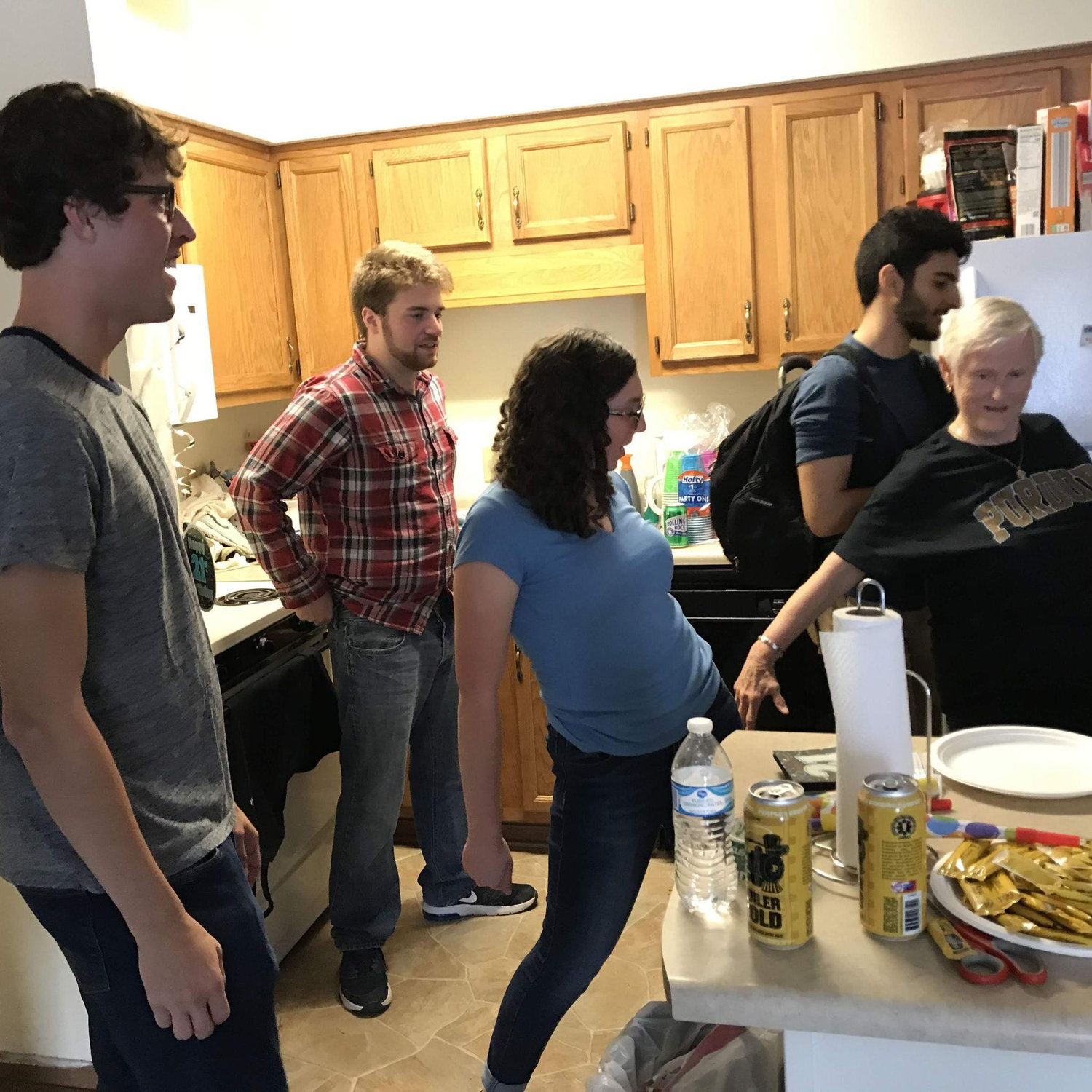 Ilana teaching Grandma Foster how to floss at Patrick's surprise 21st birthday party in 2018.
