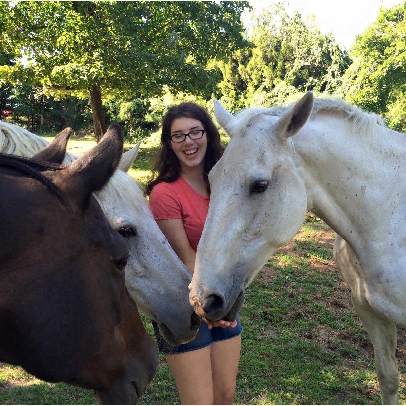 Surrounded by all her horsey loves