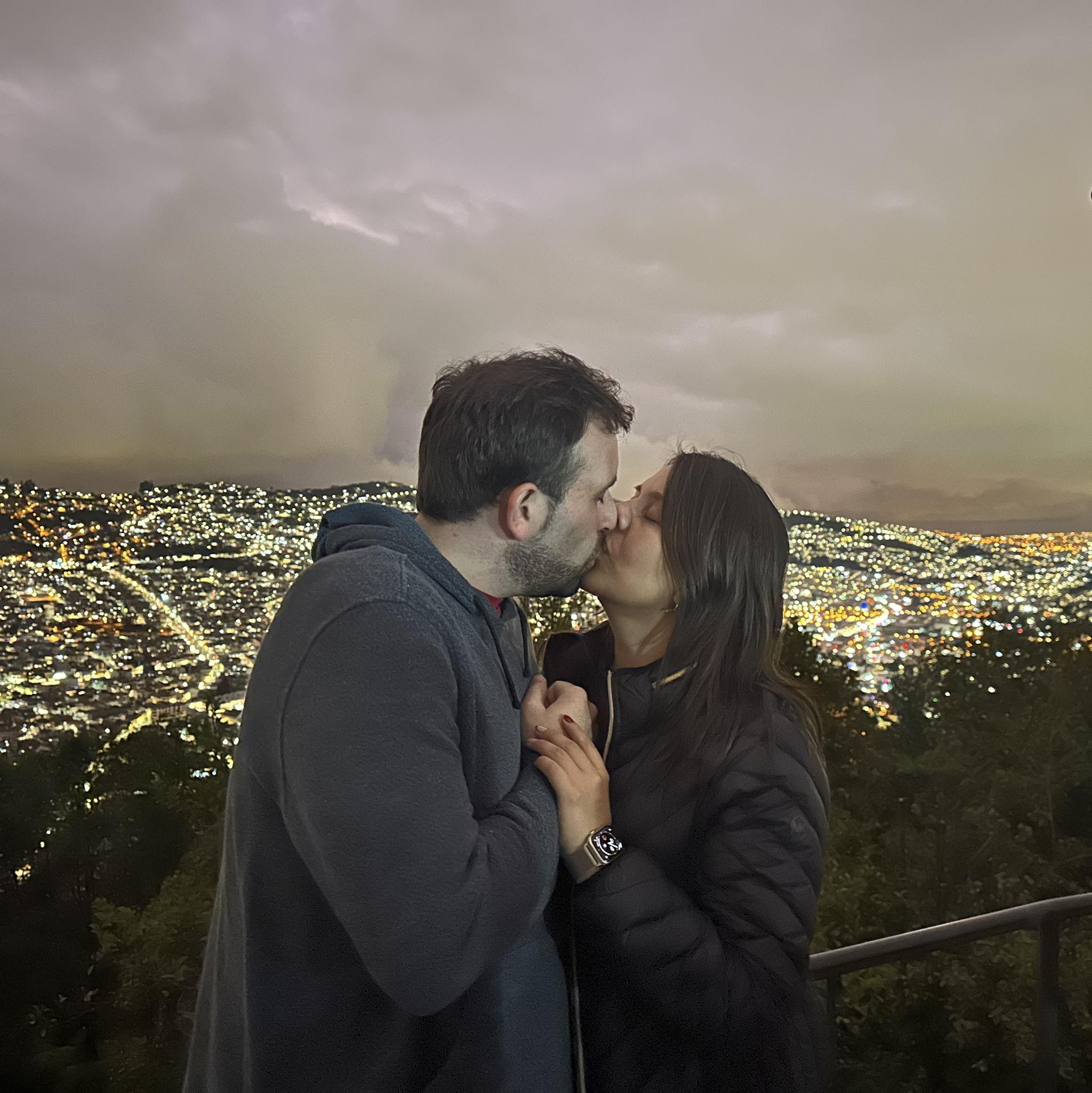 Quito - Vanessa and Michael sharing a kiss while overlooking the sweeping views of Quito.