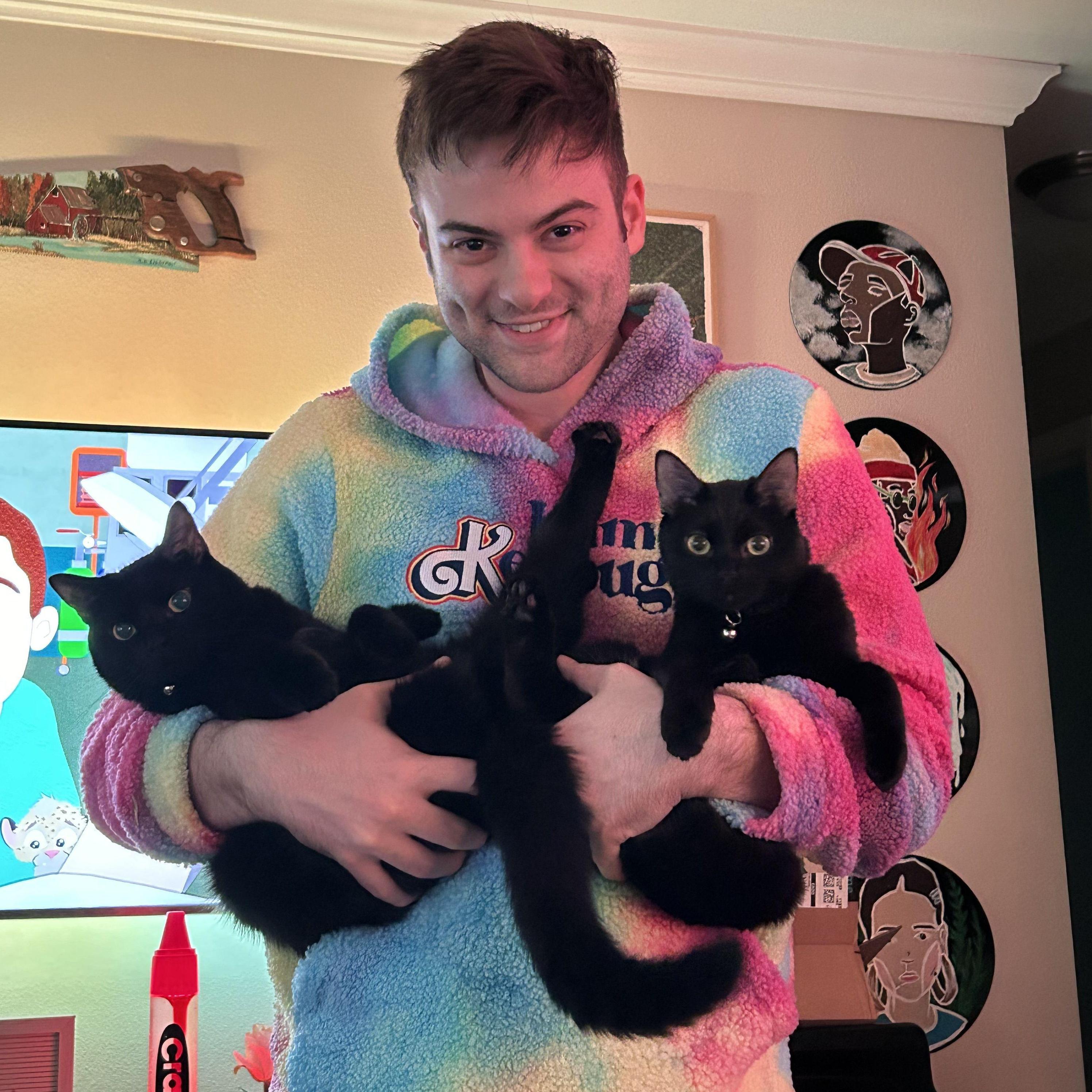 Sebastian snuggled up with our two cats: RadioShack (left) and Blockbuster (right)!