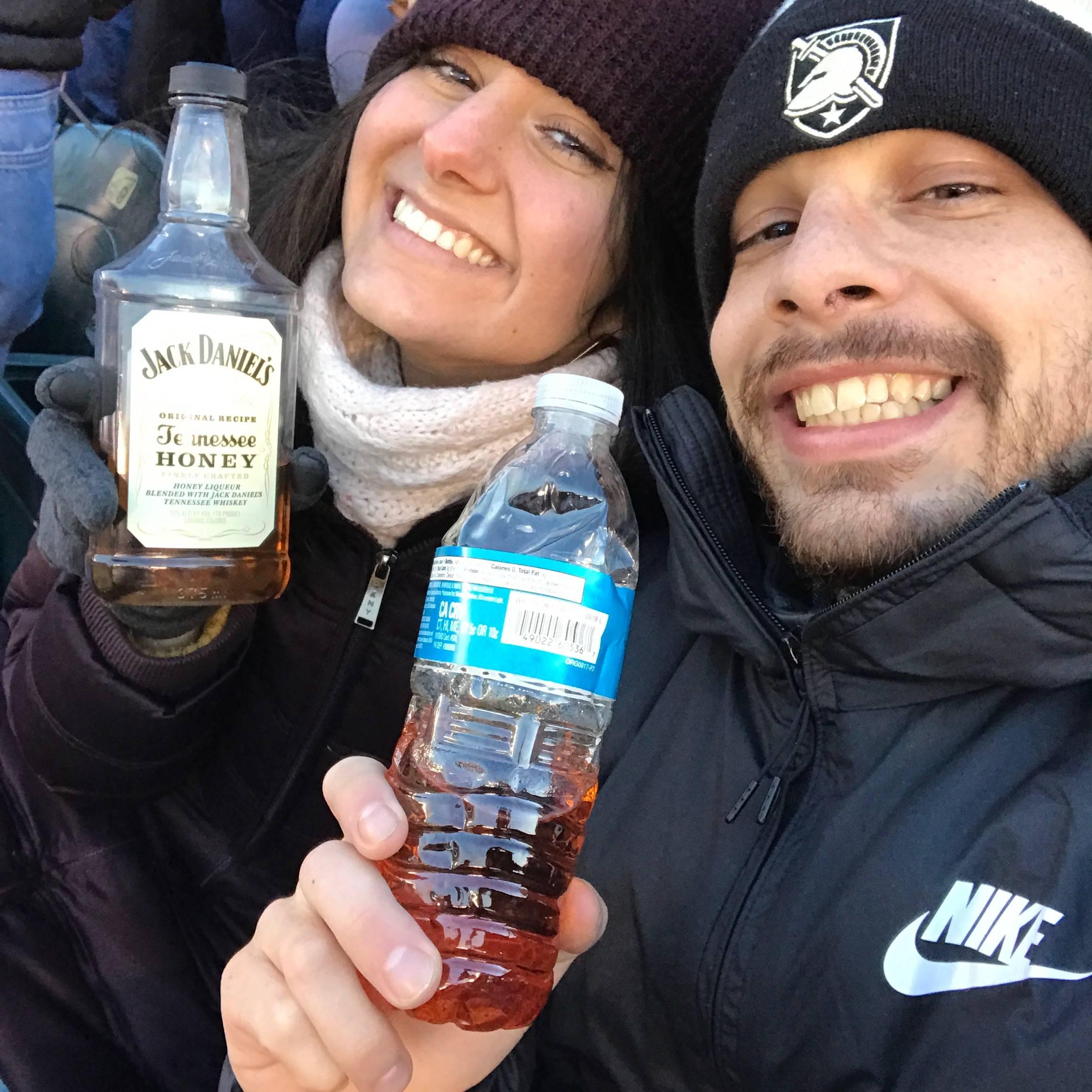 Kat and Joe sneaking alcohol into the Army/ Navy football game. Kat doesn't remember much after this photo...