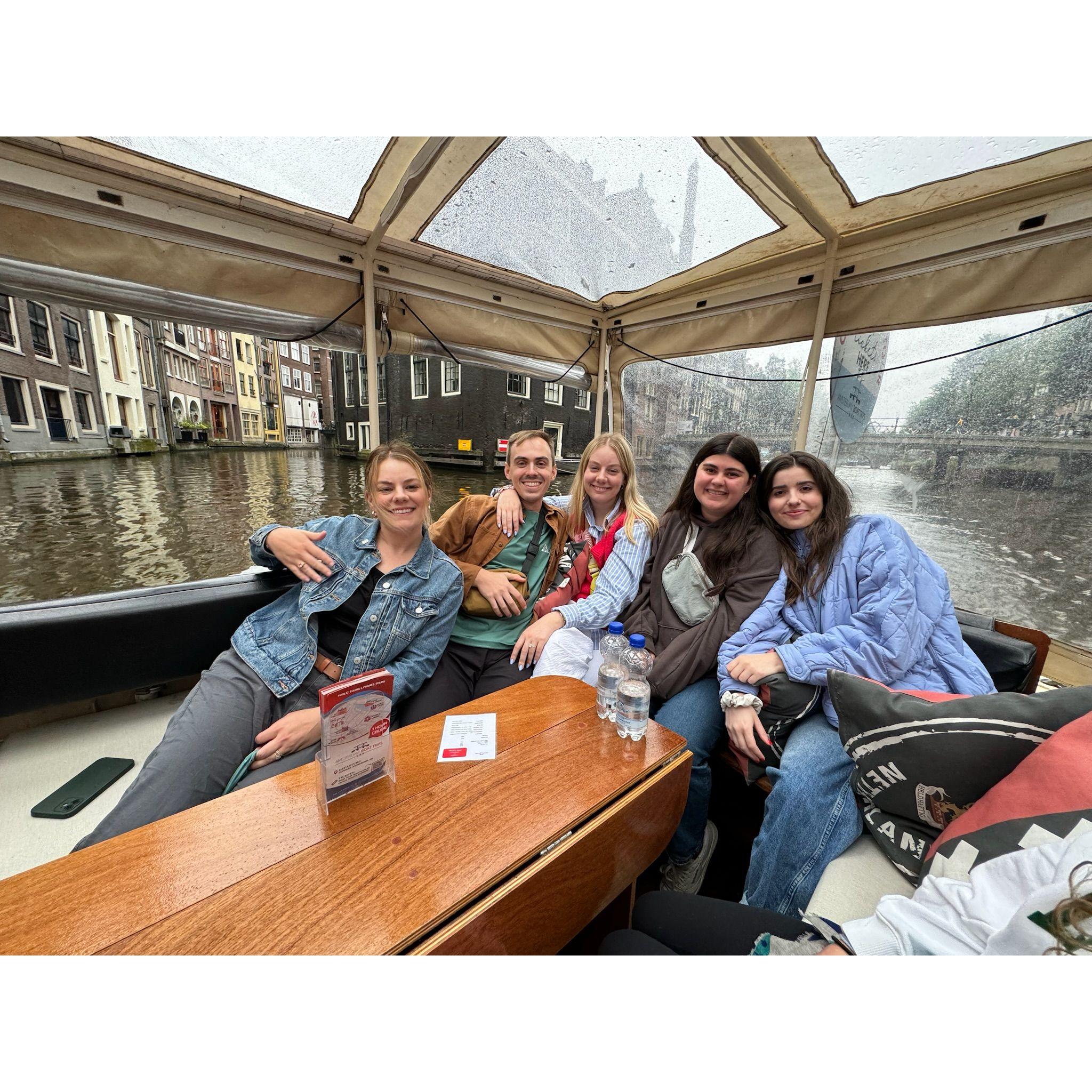 Touring the Amsterdam canal with local wine and cheese