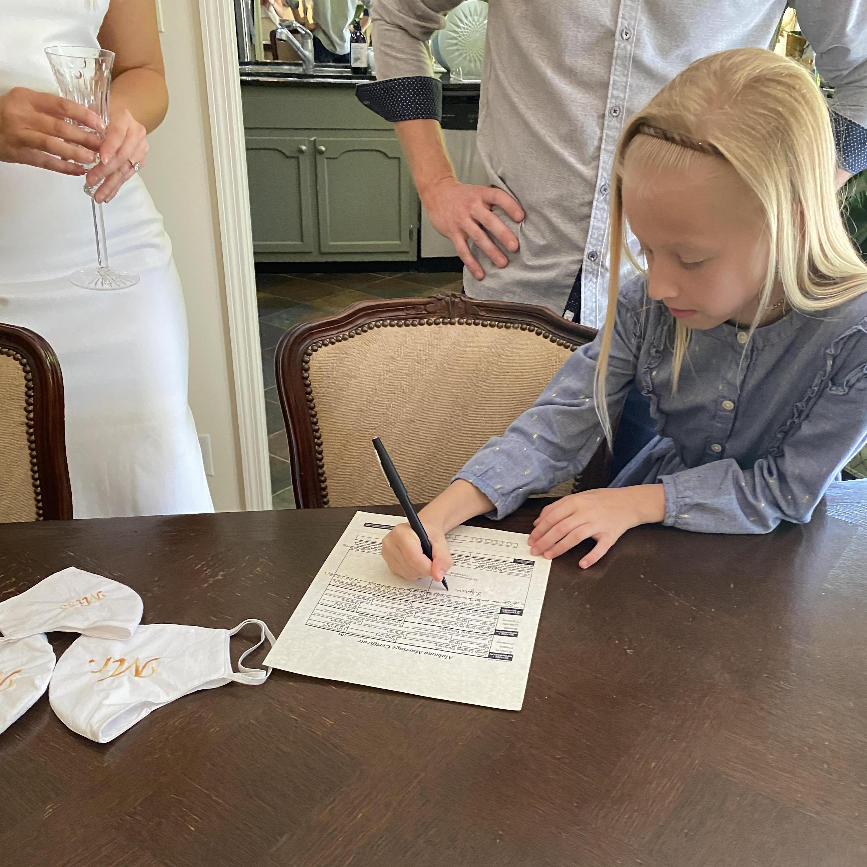Gavin's daughter Lily Claire "officiating" our wedding paperwork.