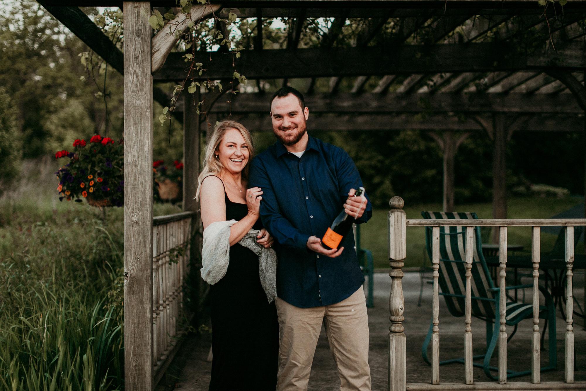 popping our favorite champagne to celebrate our engagement session, Burlington, Wi