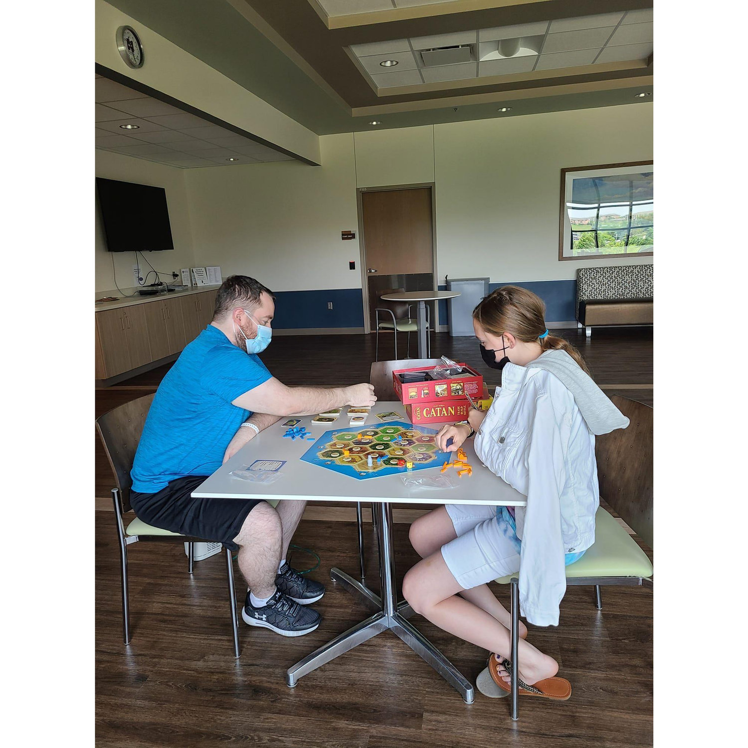 Matthew and little sister Jasmine, playing a round of Catan.