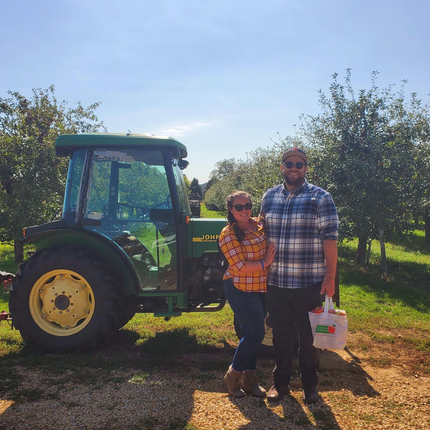 Apple Picking 2021
Alt Text: Maeghan and Keiran at an apple orchard in front of a tractor, both wearing flannel, Keiran holding a bag of apples