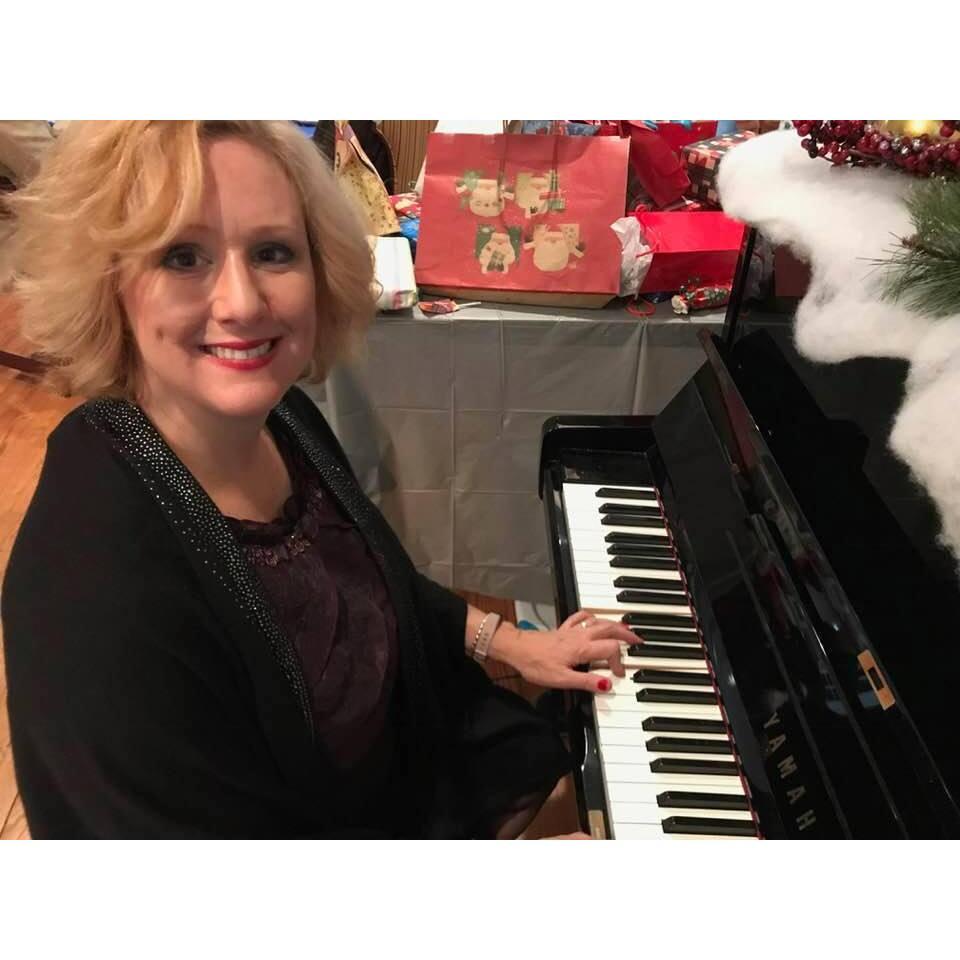 Jennifer doing what she loves- playing the piano!