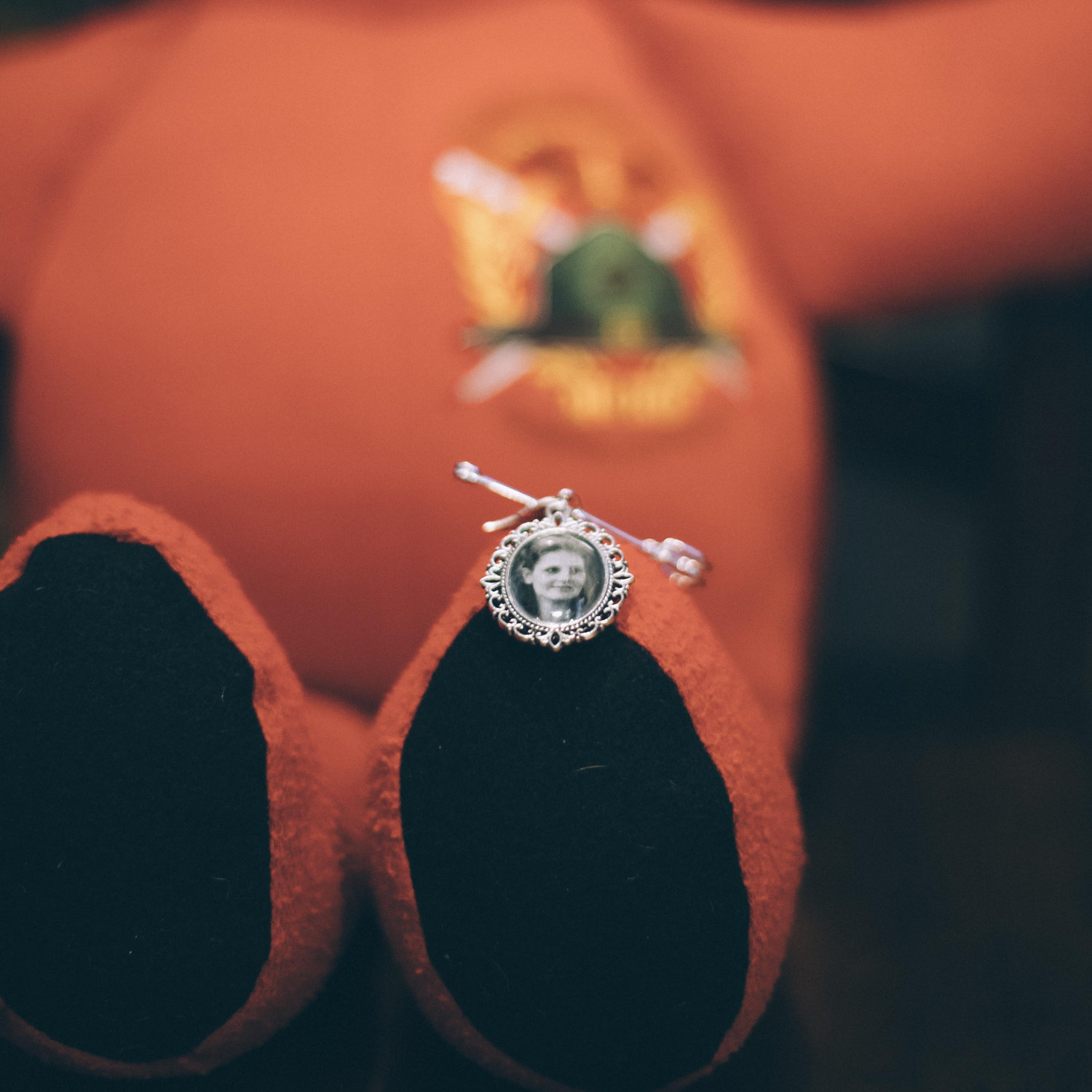 Tyler's boutonniere charm of his mom with his memory bear