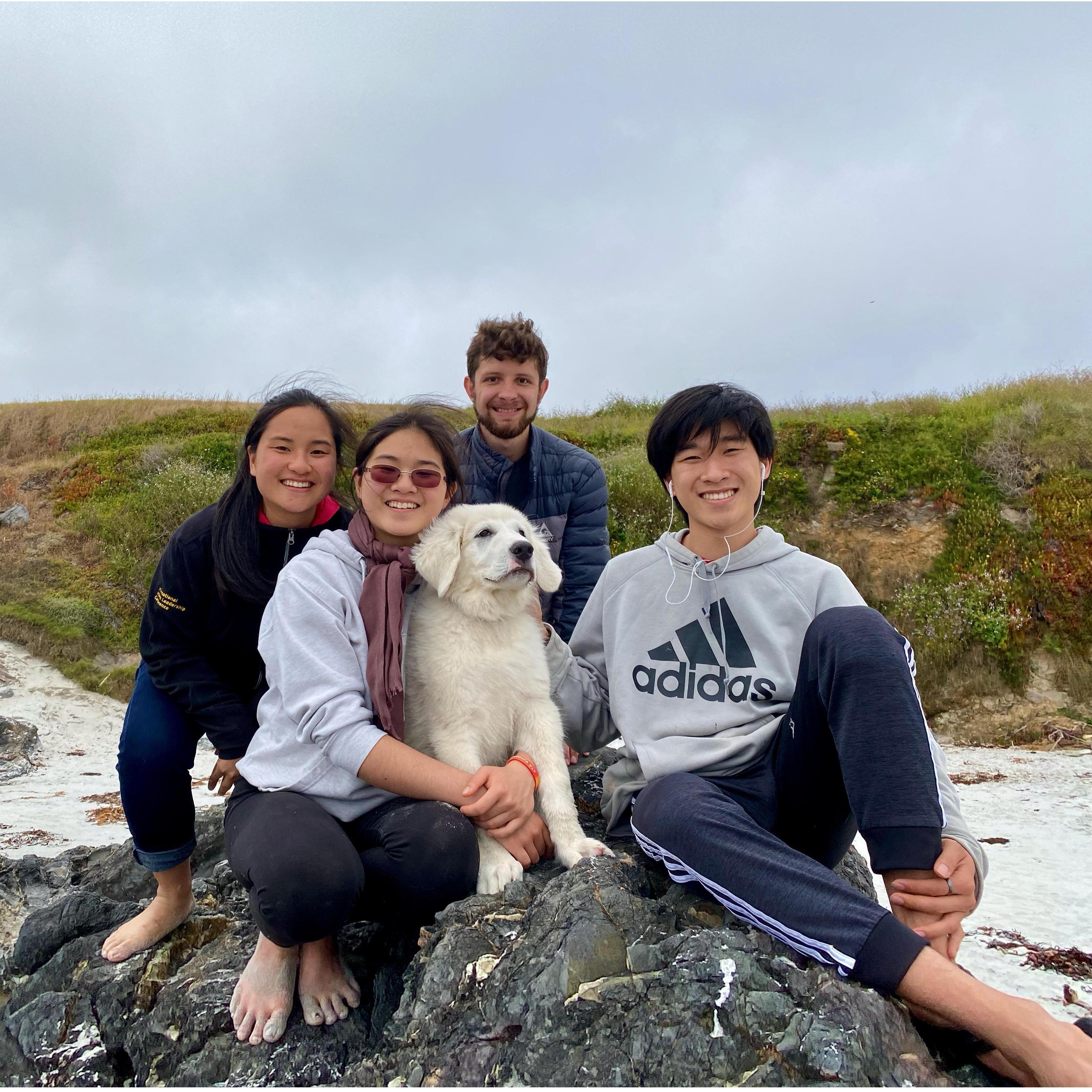 Family trip to the beach, featuring Xiao Bai as a puppy