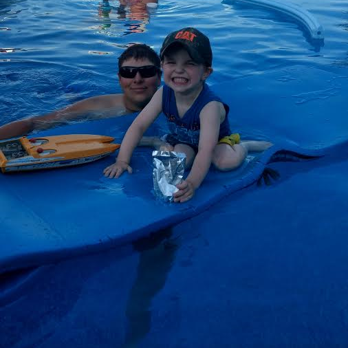 Matthew and his best friend after he finally worked up the courage to get in the pool.