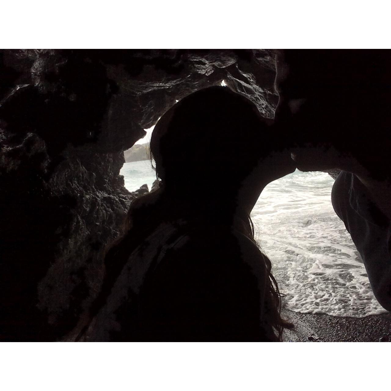 Kissing in a cave on a black sand beach in Hawaii. On our baby moon :)