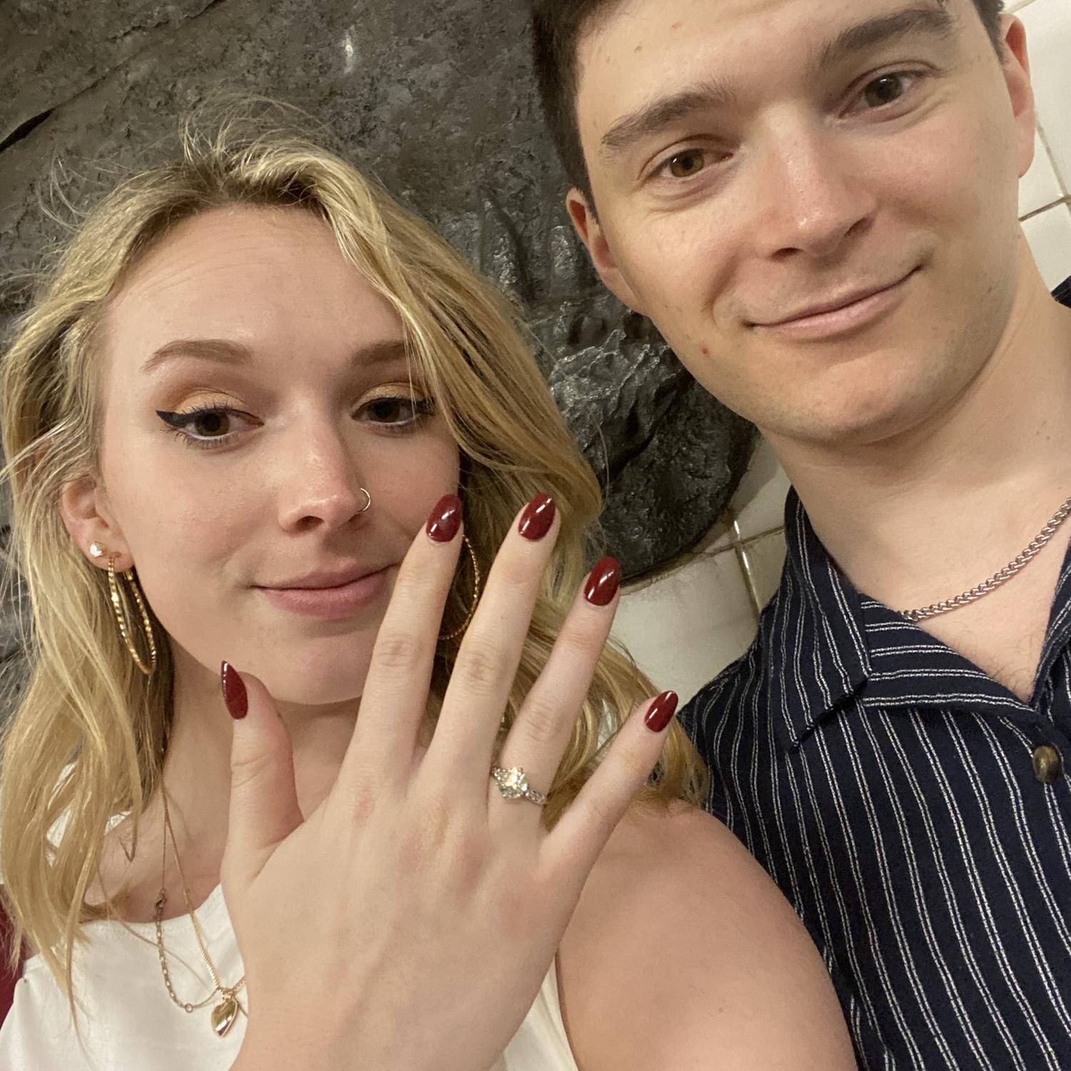 The picture we sent to family in the New York subway after Riley proposed.
