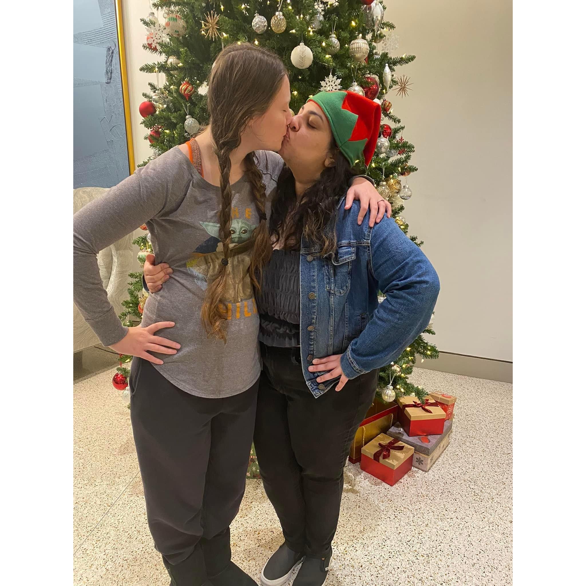 In front of the Christmas tree in Momo's apartment building