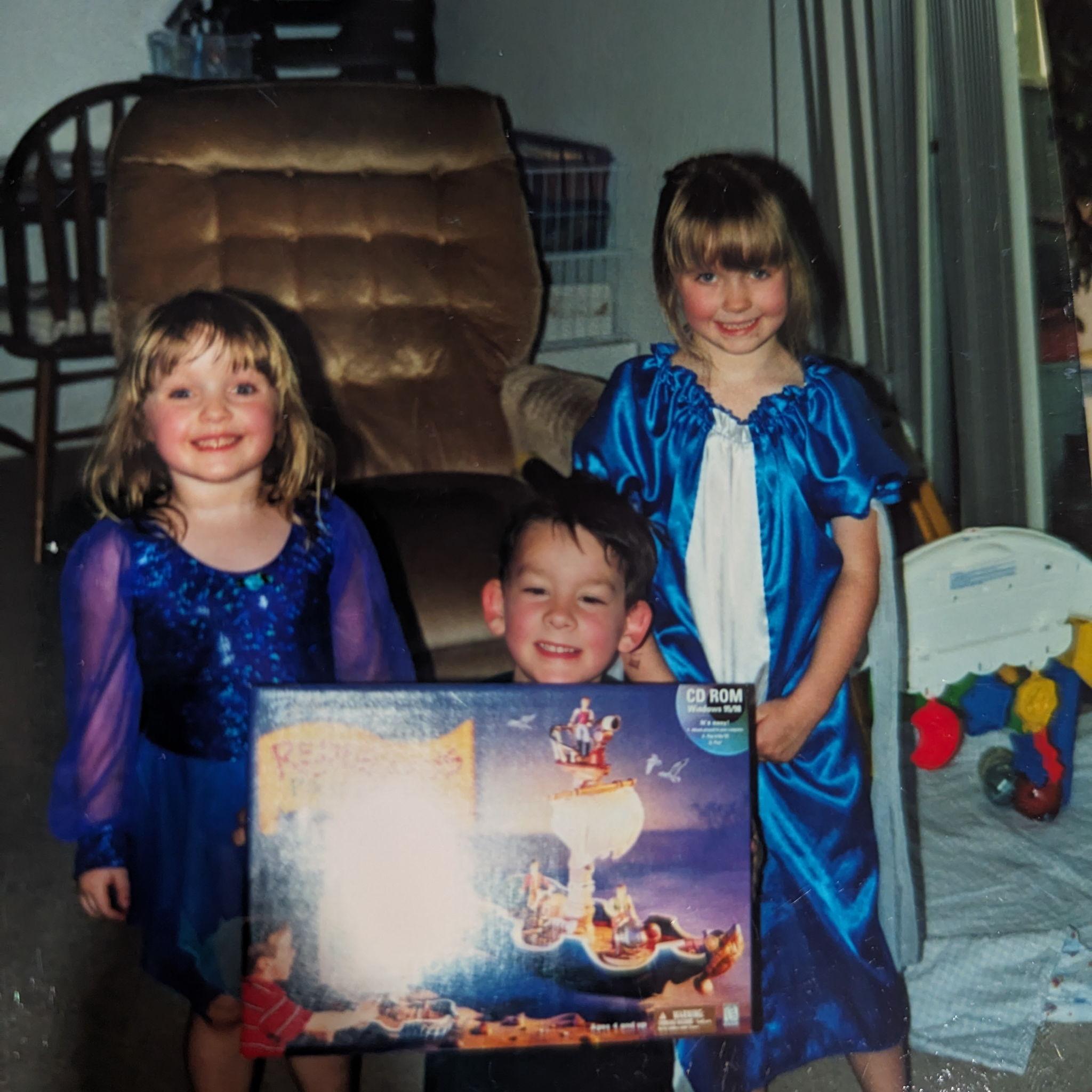 Jessi, Ry, and Tay at Ry's birthday party, giving him the first video game we ever played together