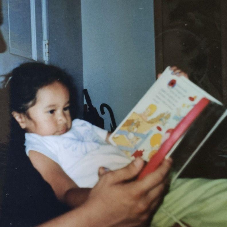 Milla reading a book with who would one day be her Nino.