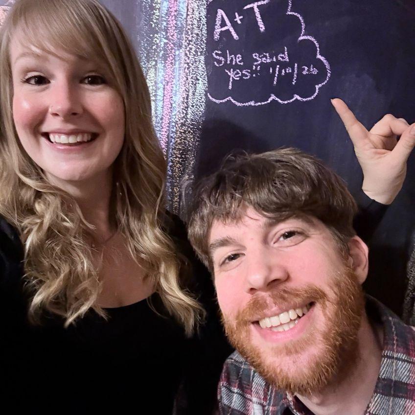 She said "yes!" on the chalkboard in the Air BnB where Tom proposed.
