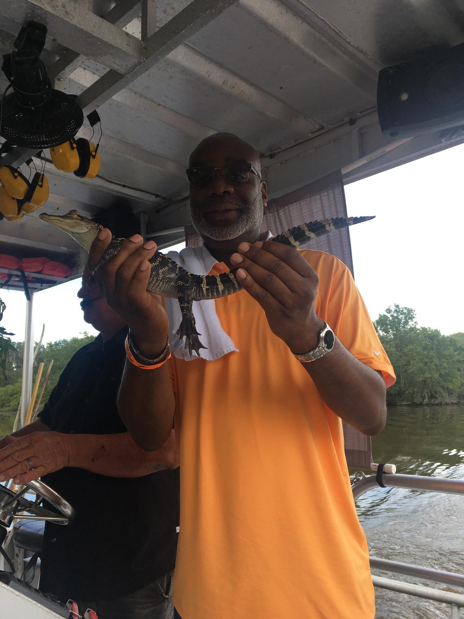 Raymond holding a baby gator on a Swamp tour