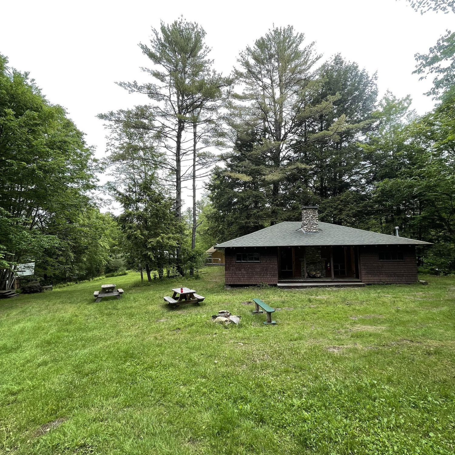 Tent bath house and common space. Electricity with 4 showers, 4 toilets, 6 sinks and mirrors. There is also a living space in the middle with couches.