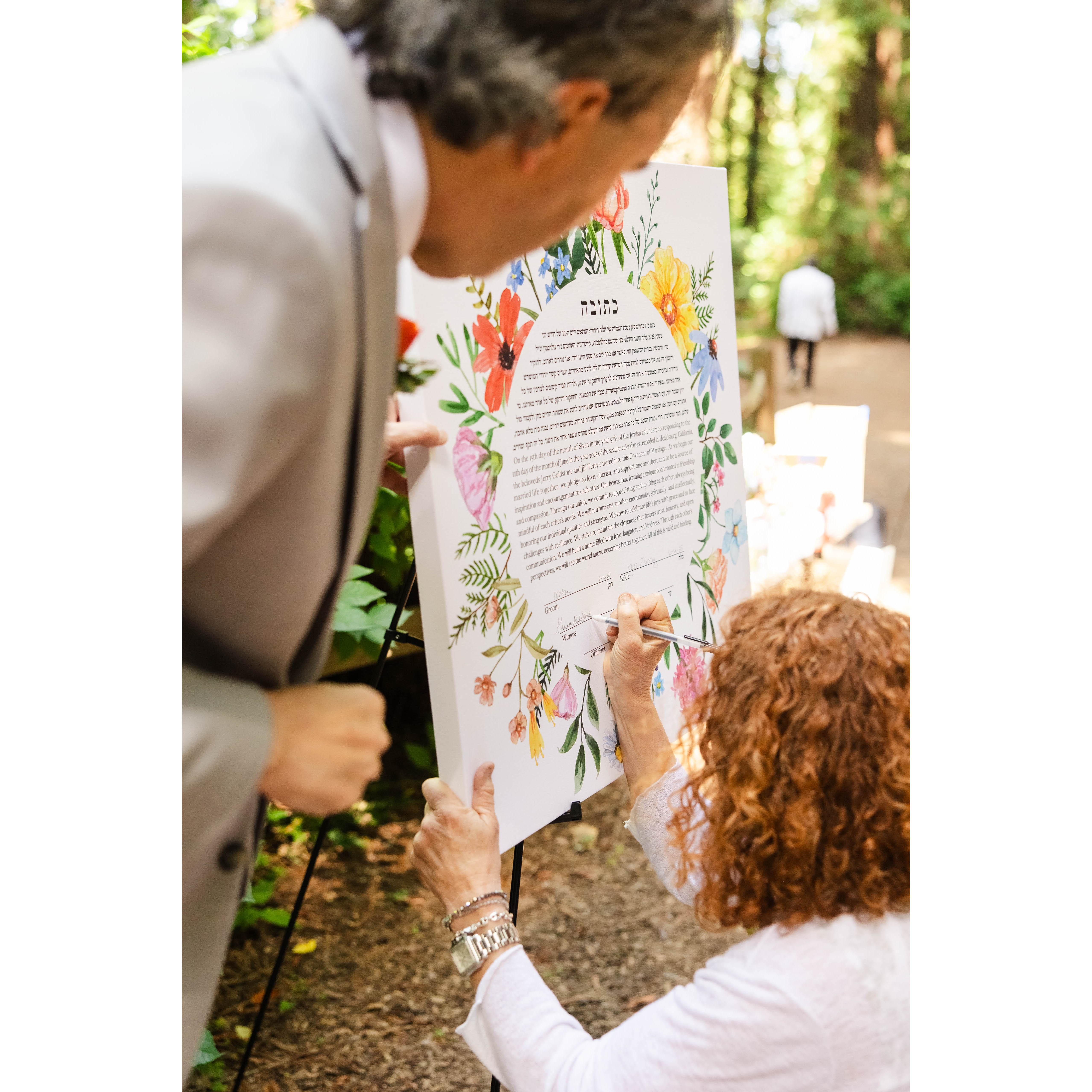 Sharon signs the ketubah as a witness