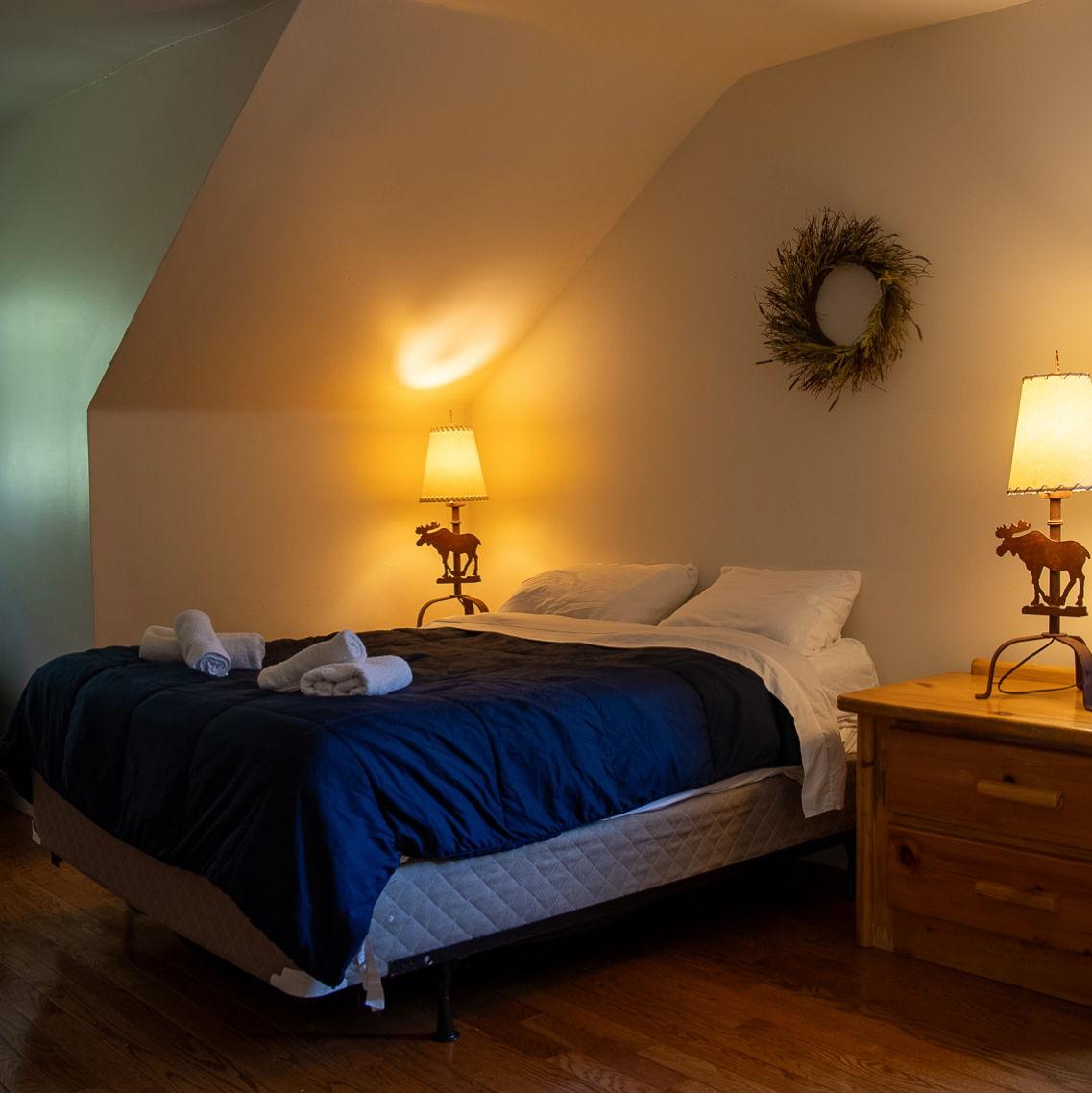 Sneak peak at the private accommodations at Camp Lindenmere - room with a queen size bed!