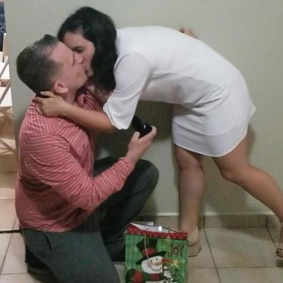 Ian on his knee proposing, Christmas Eve 2018.