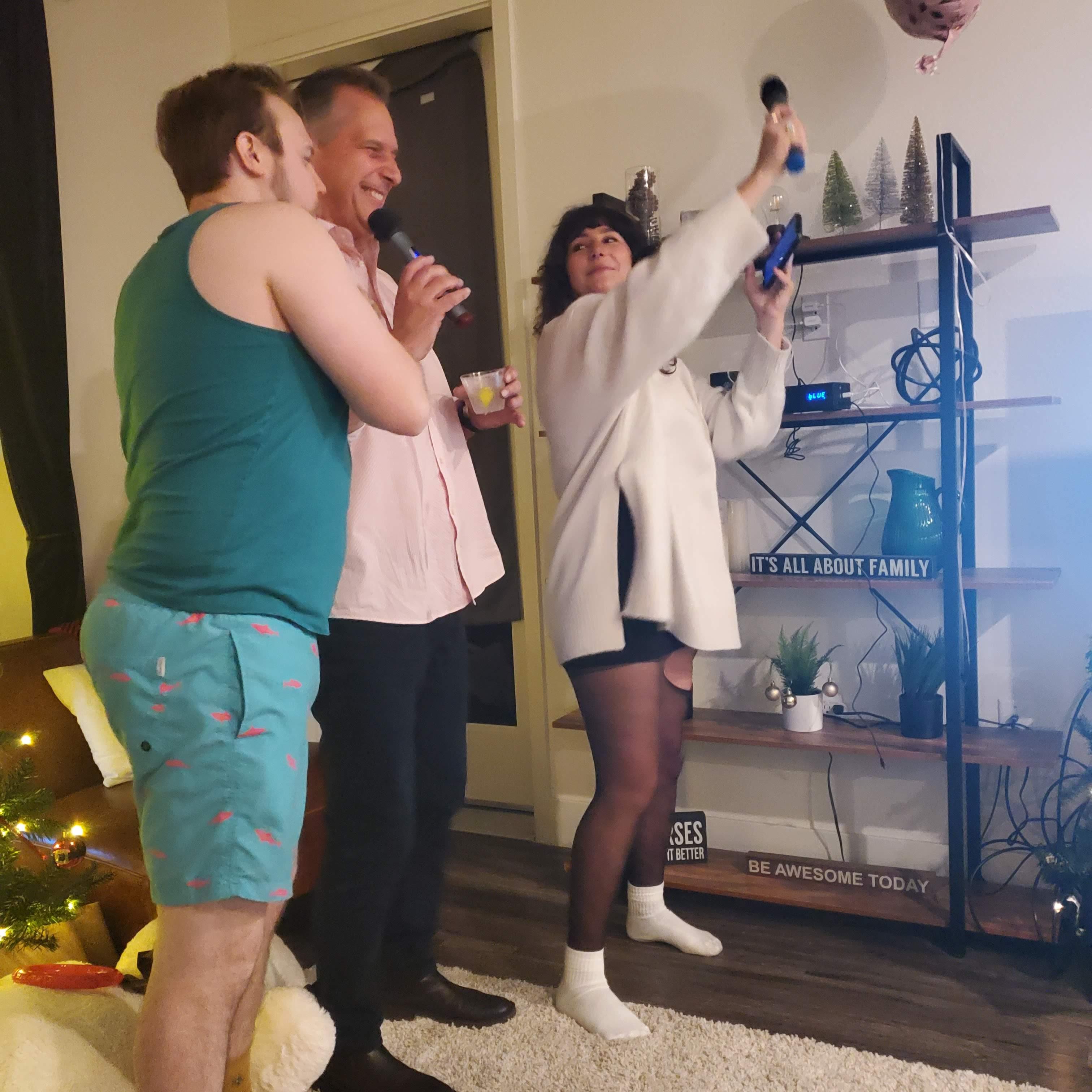 Dan, Michelle, and Travis doing karaoke.