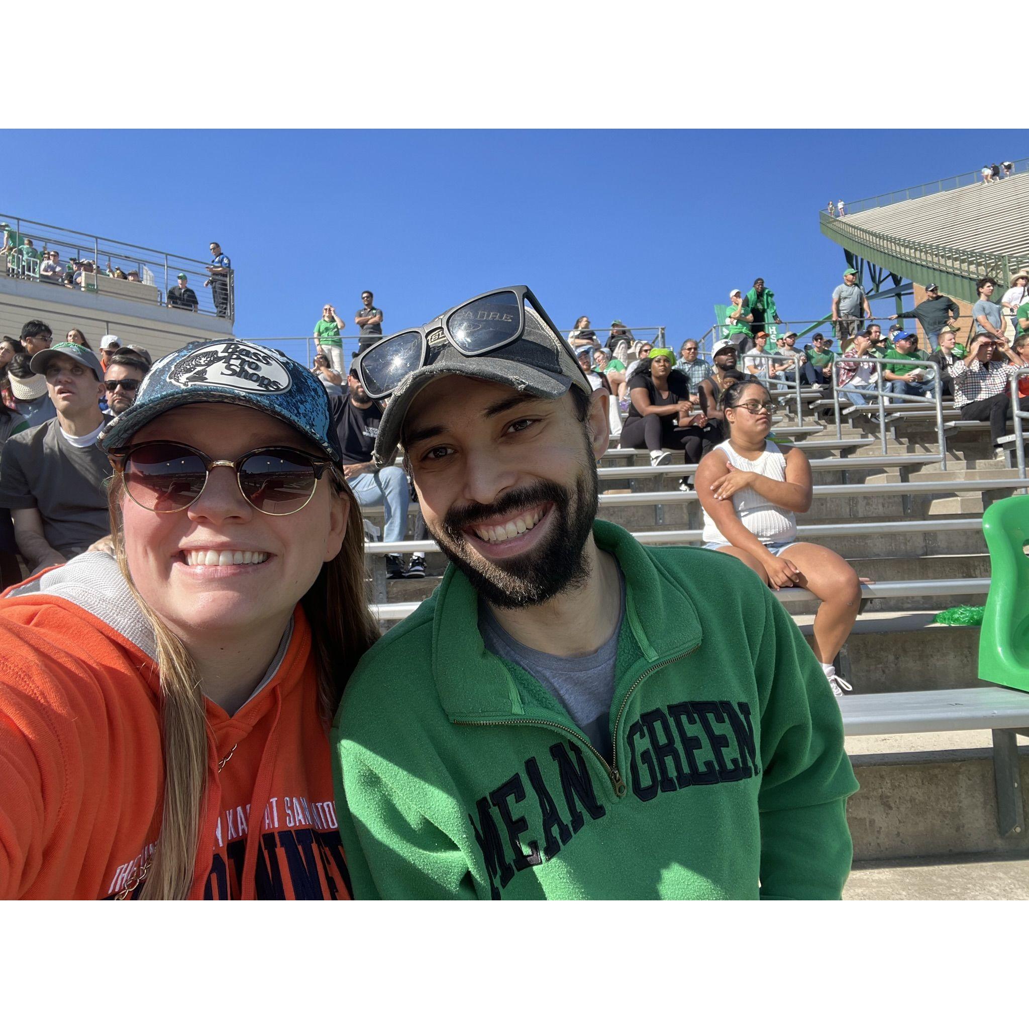 Us at a football game where the Roadrunners crushed the Mean Green (duh).