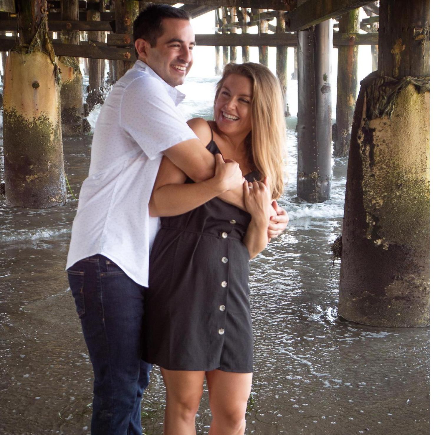 Engagement photos taken under the Pacific Beach Pier in San Diego