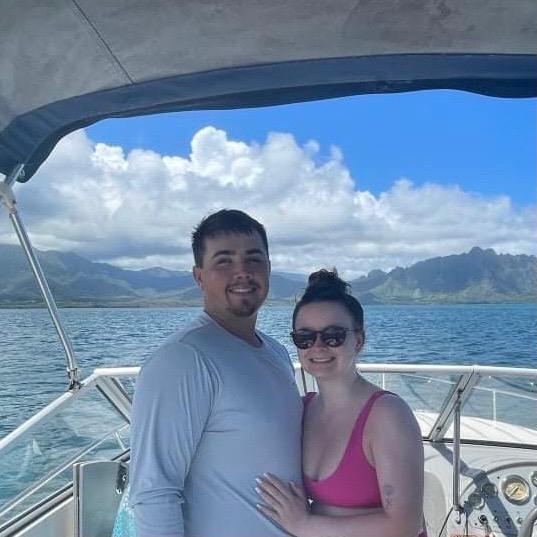 Dustin and Maya on a sandbar in Hawaii with friends 2021