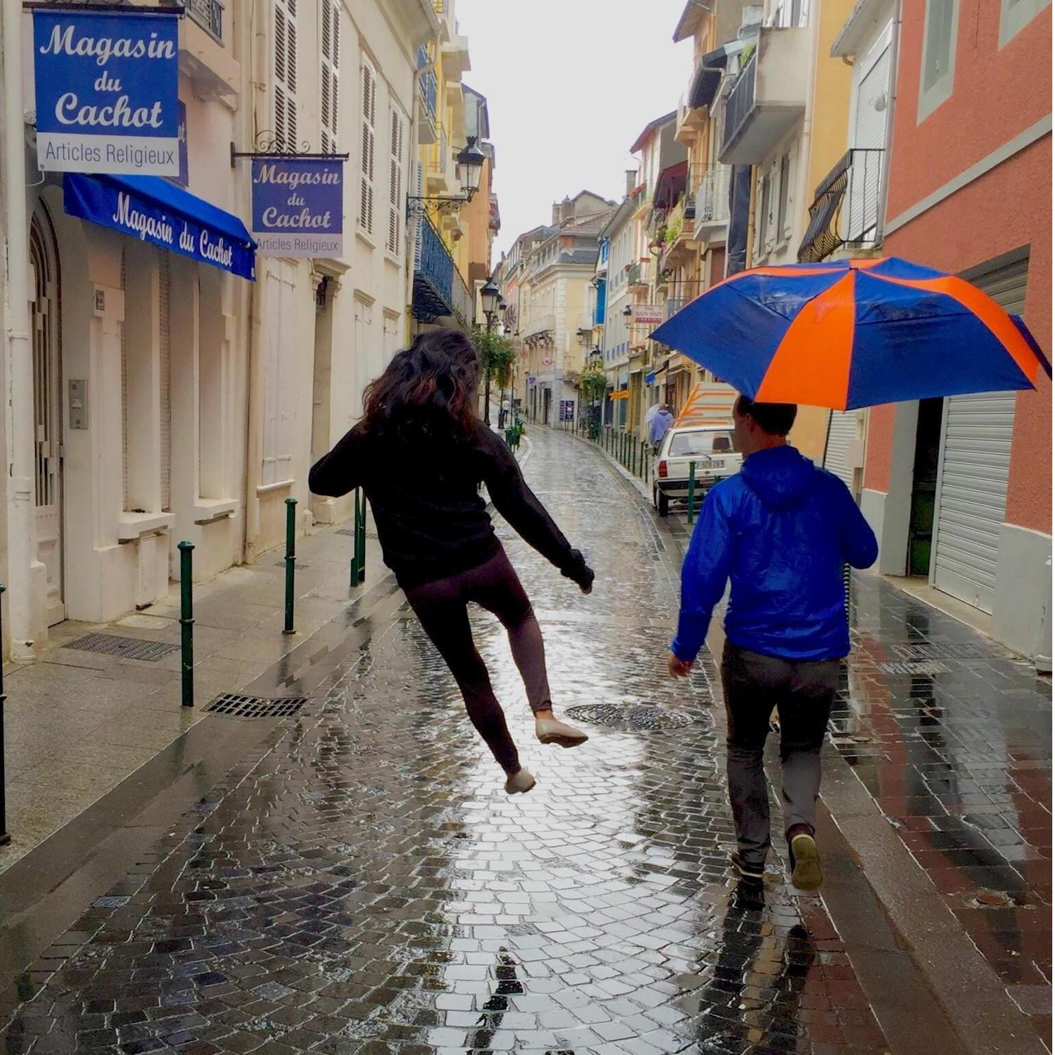 Dancing in the rain down the streets of Lourdes, France.