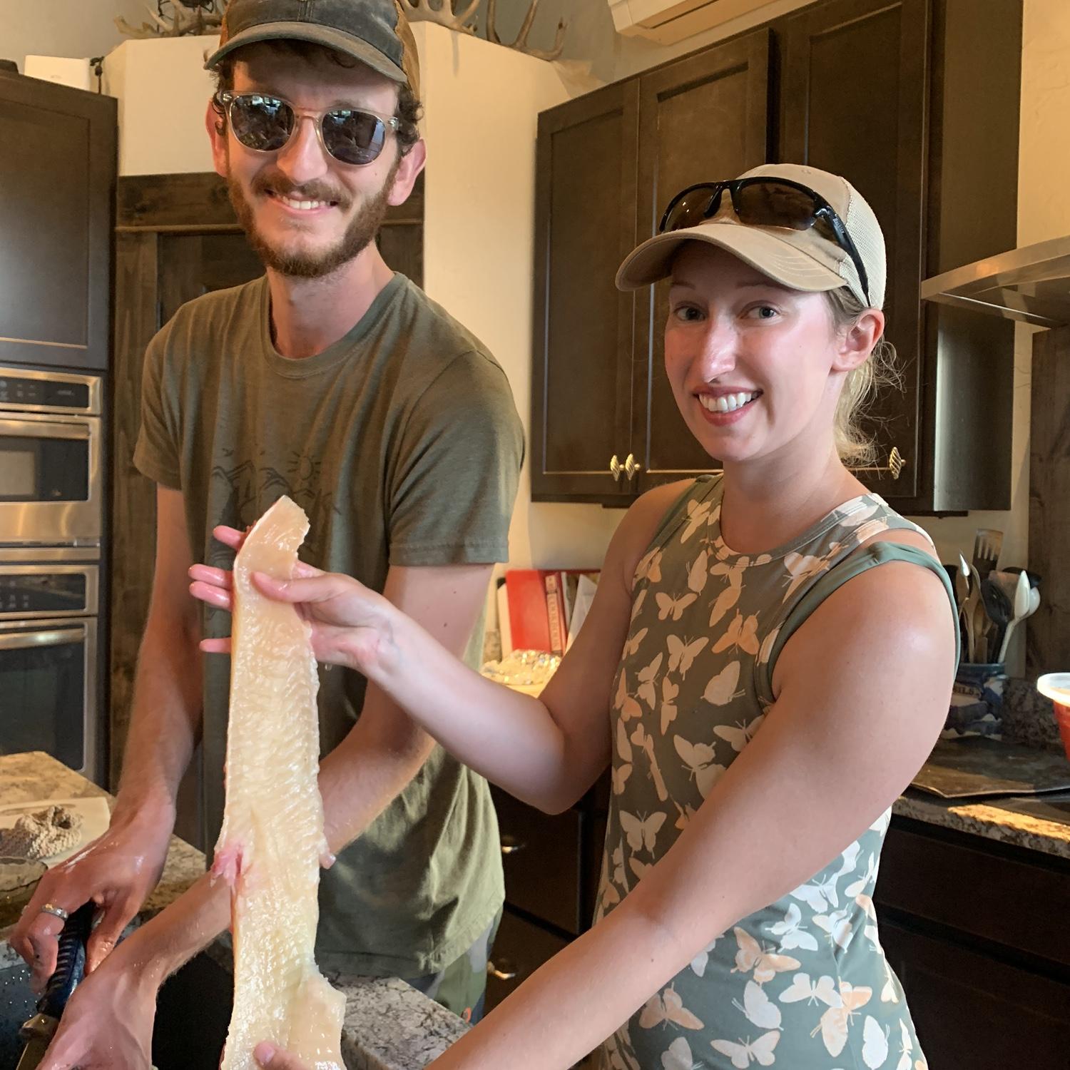 Filleting and cleaning Pike that Riley speared in Salmon Lake. August 2022