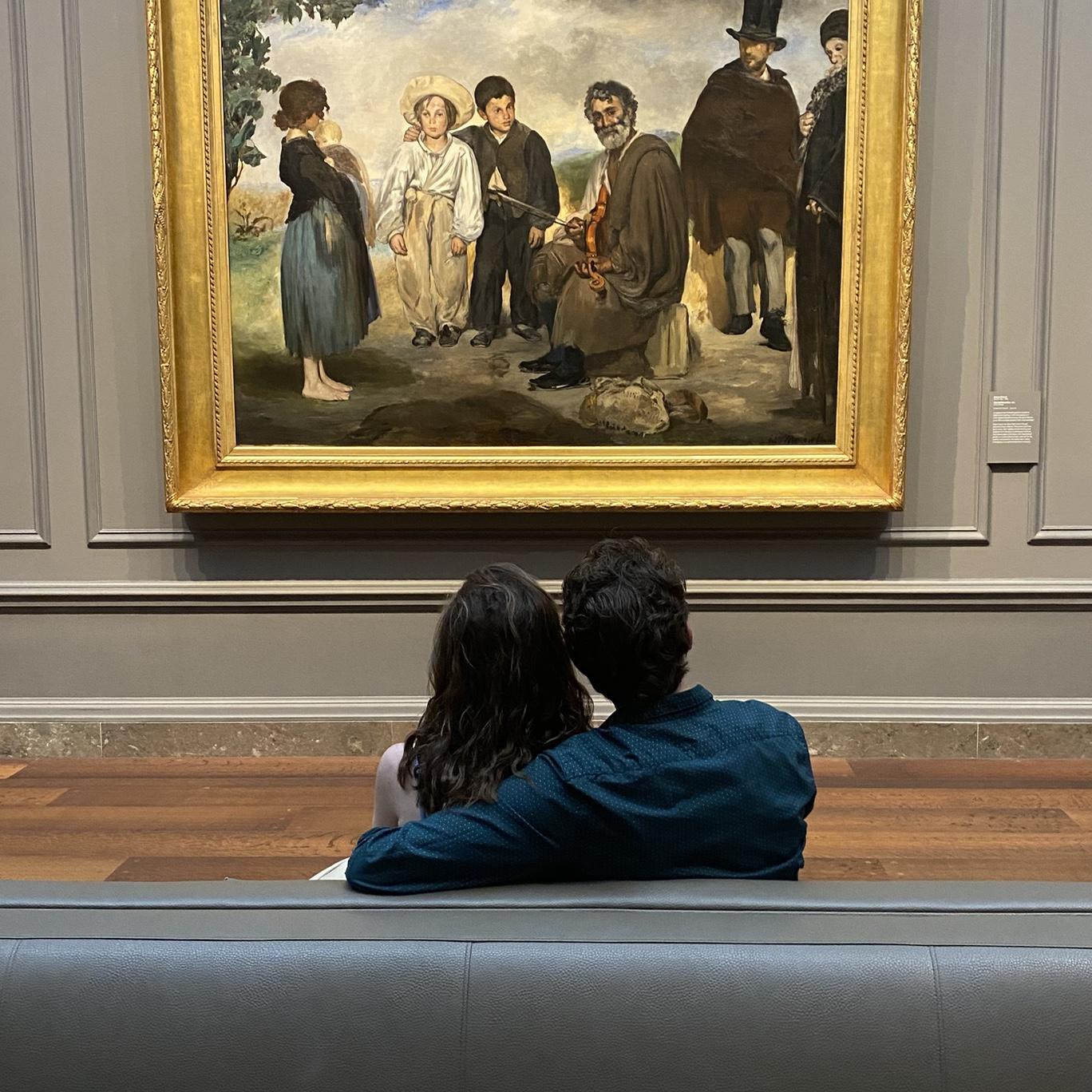 09/21/2024 - Ana's dad snapped this photo of them sitting in front of Michael's favorite painting at the NatGal. Later, Michael's mom posted it on Facebook, with the caption, "Michael has found the love of his life," prompting some people to think they had gotten engaged... whoops