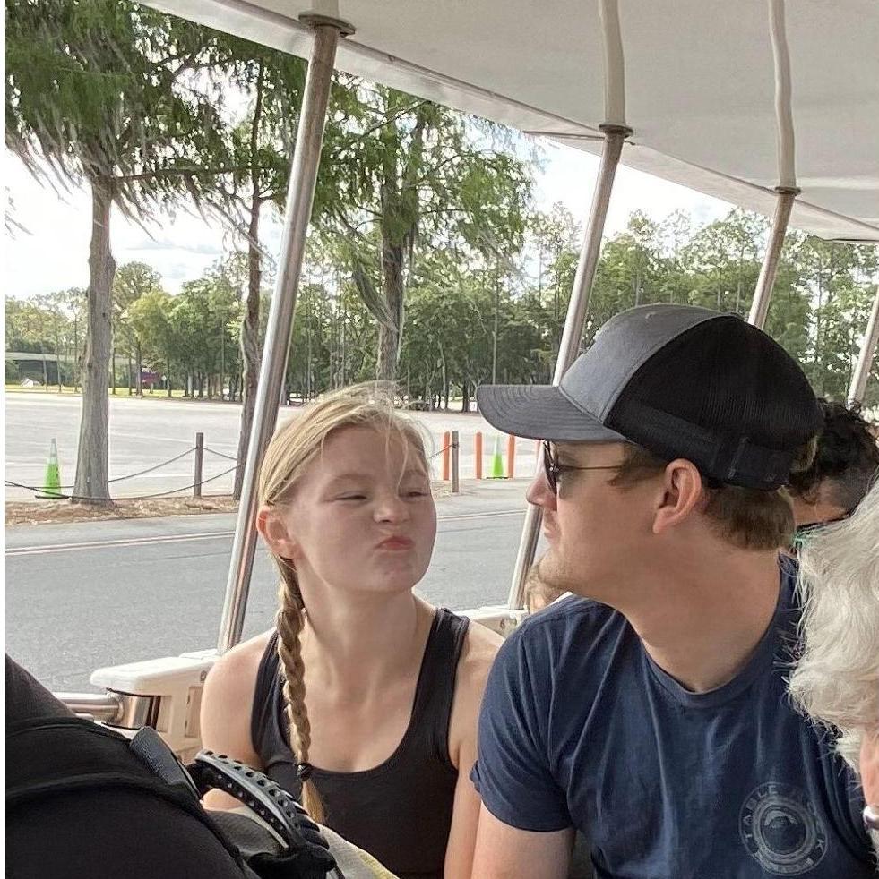 Brandon's dad caught the two making silly faces at each other on the tram at Disney.