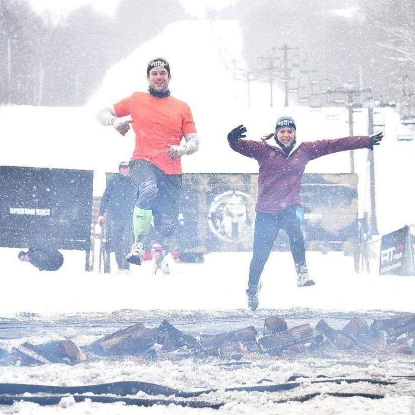 2018 - Jumping over the finish line fire with frozen feet and fingers. This was definitely one of the coldest mountain obstacle course races we had the courage to run.