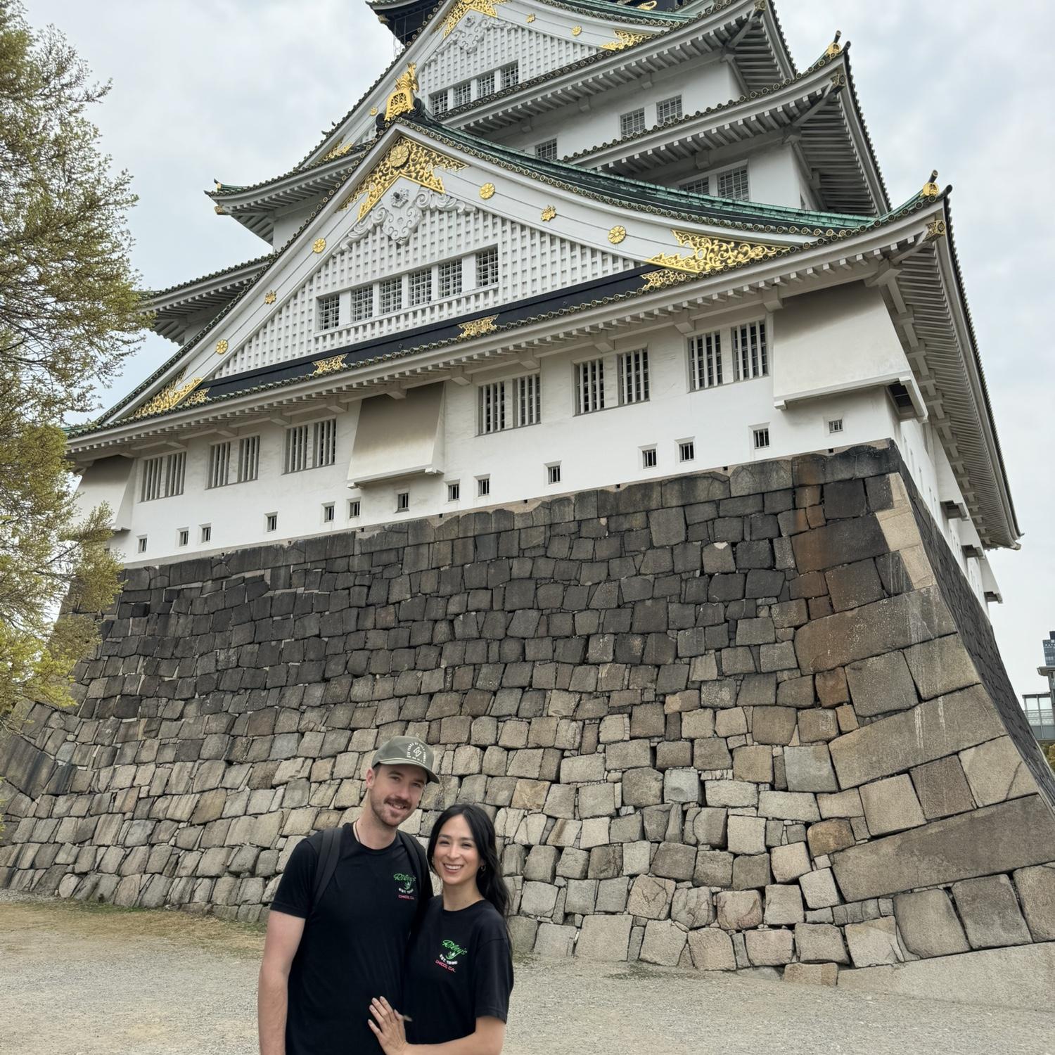 Traveling the world together! A picture from Osaka, Japan 2025. We are wearing matching shirts from the bar we met at.
