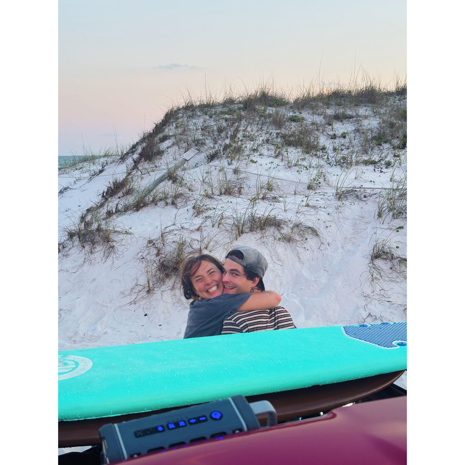 In this photo Caed had just re-proposed to me with my ring I had replaced with an athletic ring for the ocean and some girls said congratulations