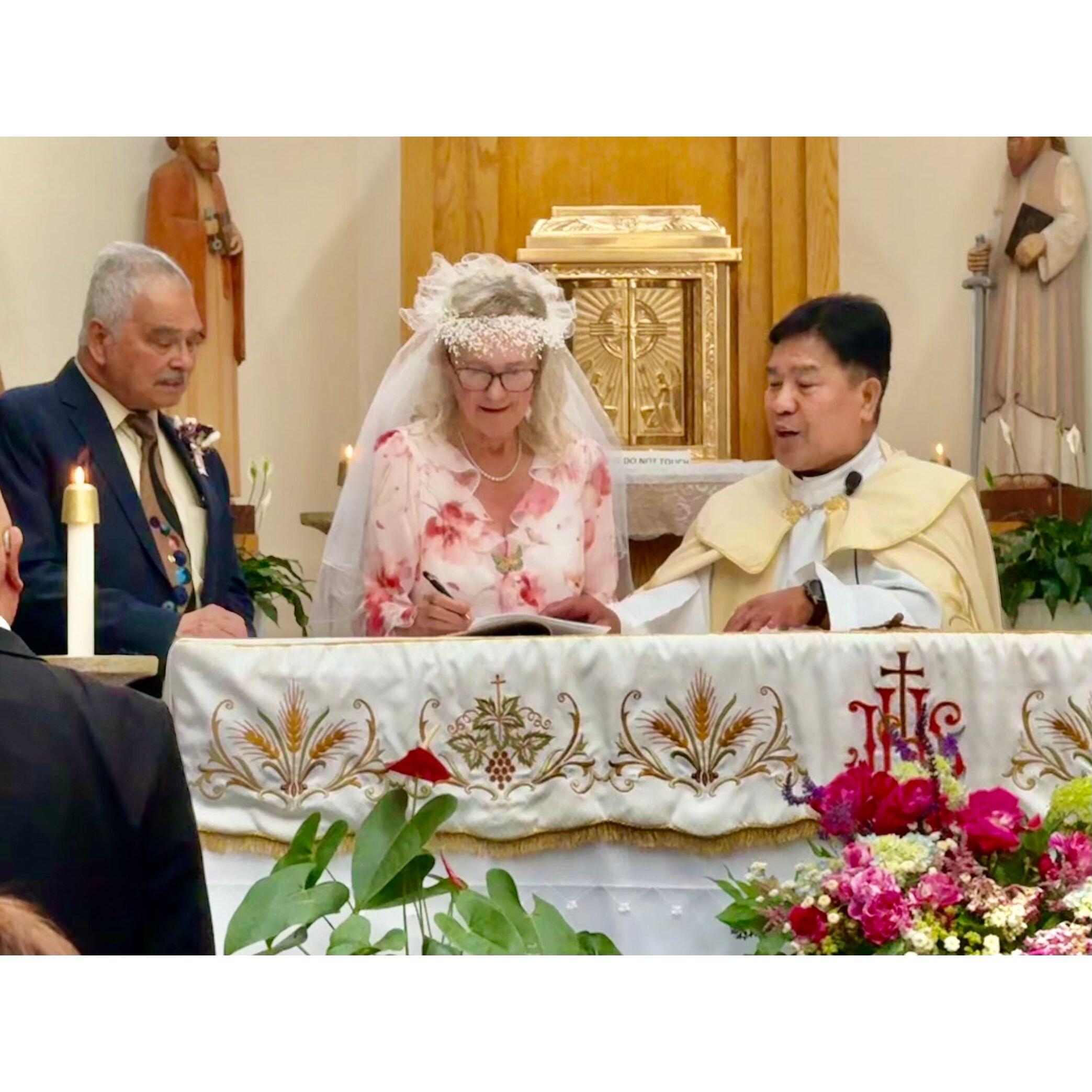 Anita signs the register.