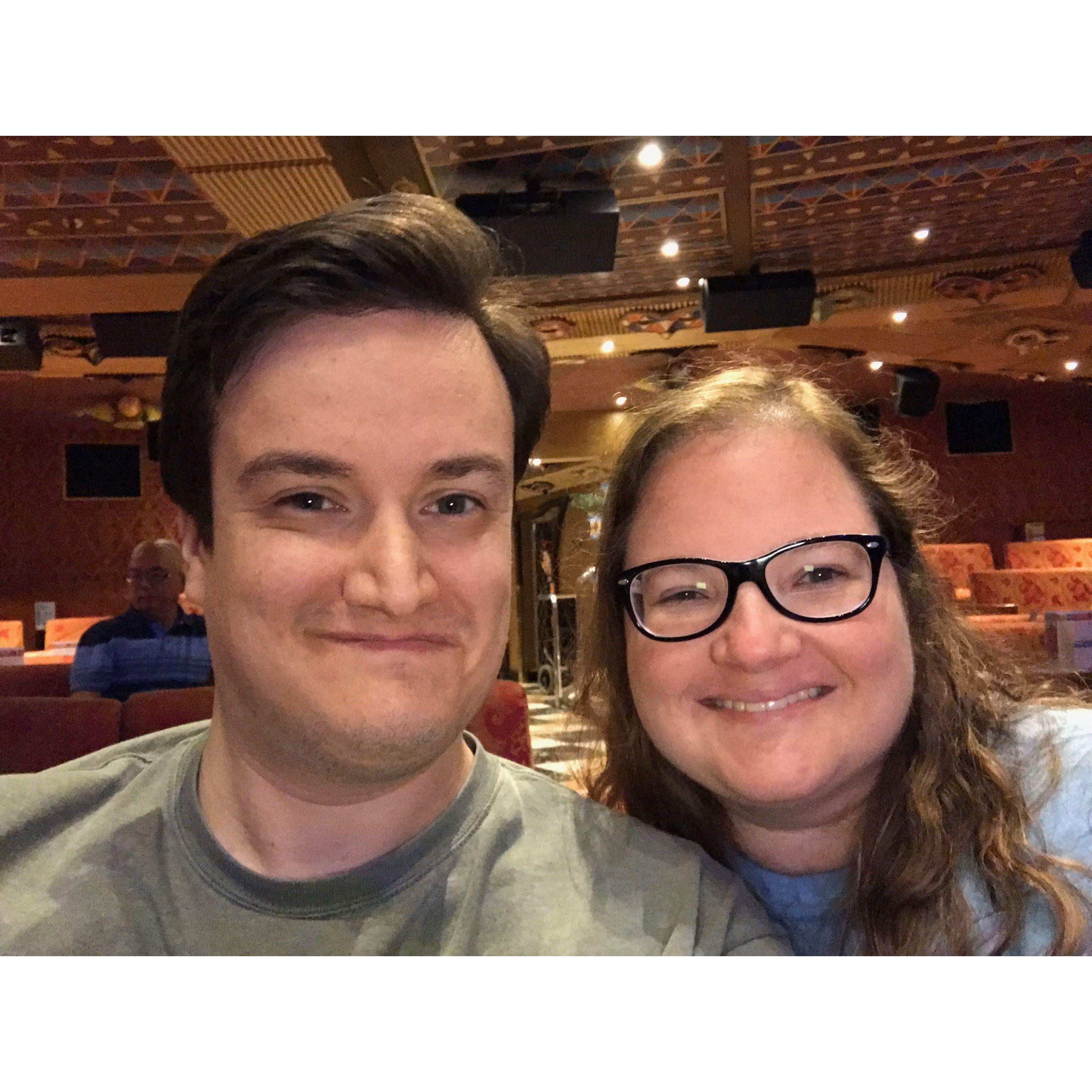 Selfie of the couple inside a fancy event space on a cruise ship.